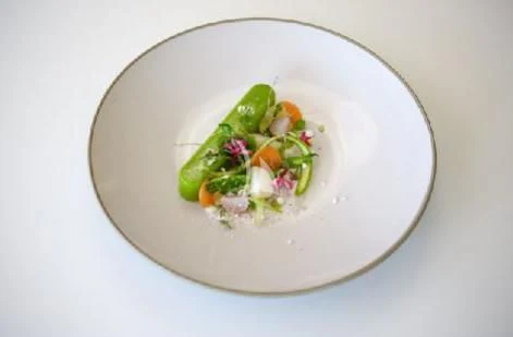 a white bowl with food in it aboard PANDION PEARL Yacht for Charter