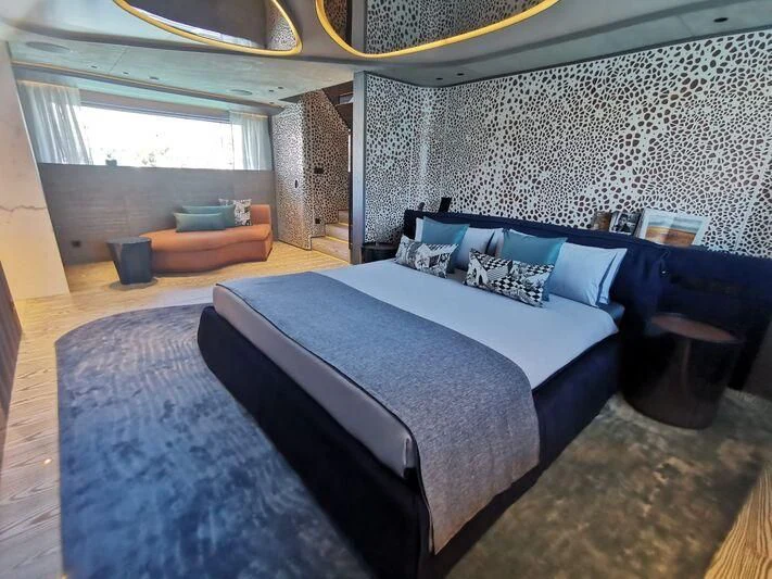 a blue bed in a room aboard PANDION PEARL Yacht for Charter