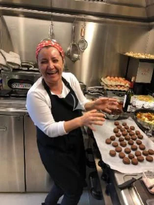 a woman in a kitchen aboard PANDION PEARL Yacht for Charter