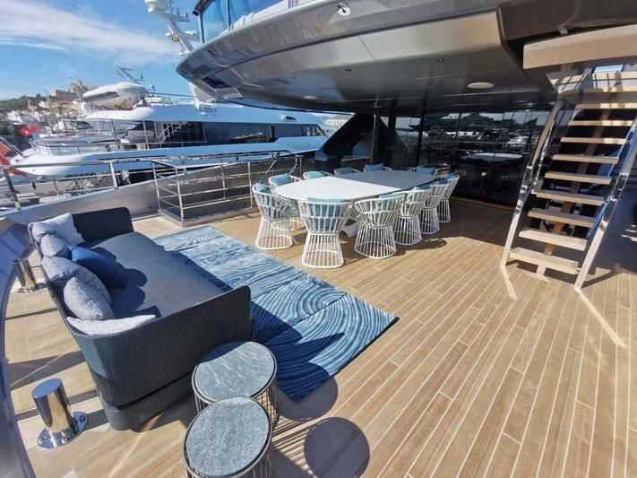 a deck with a large cruise ship in the background aboard PANDION PEARL Yacht for Charter