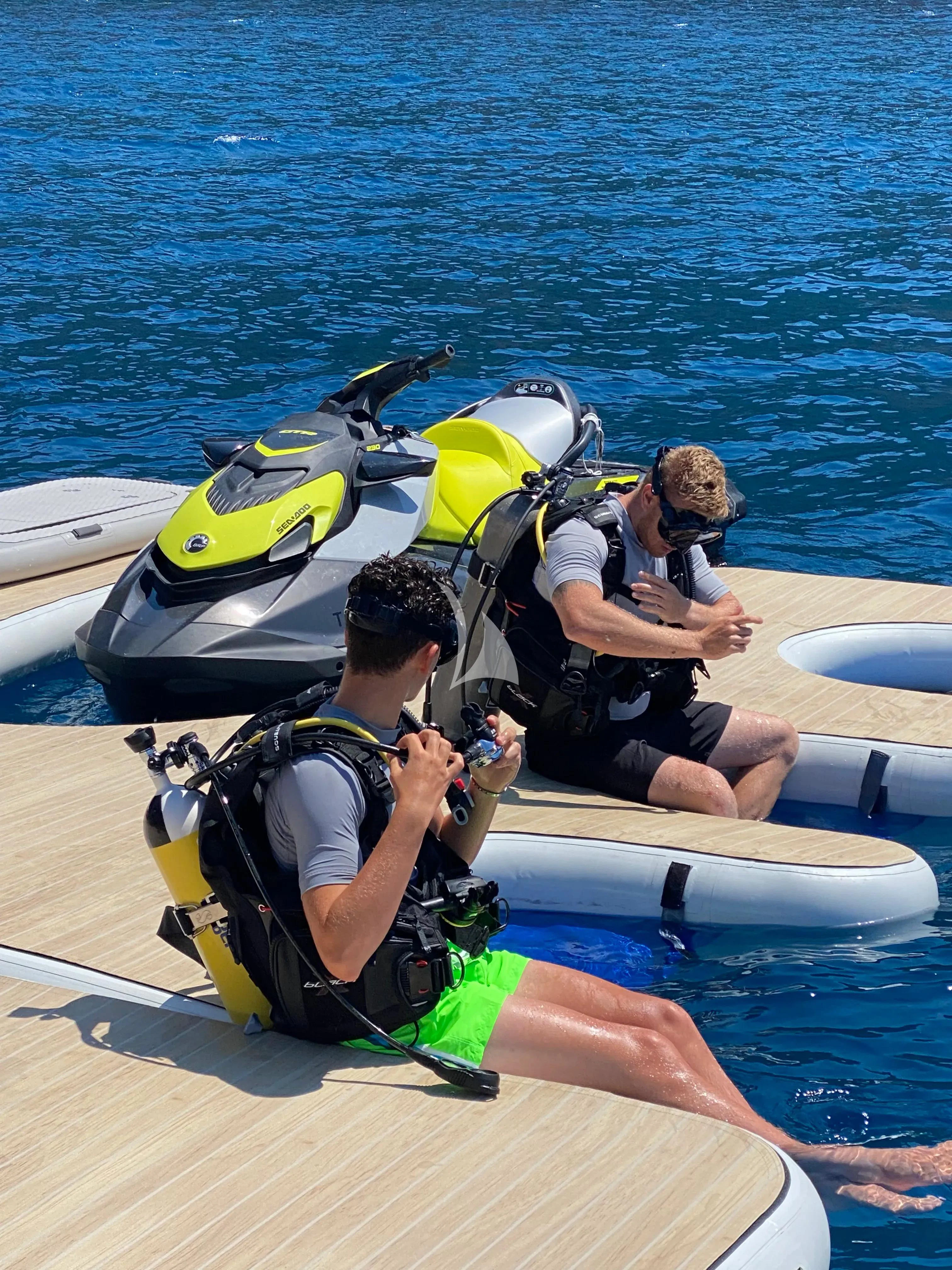 a group of people in life vests on a boat aboard PANDION PEARL Yacht for Charter