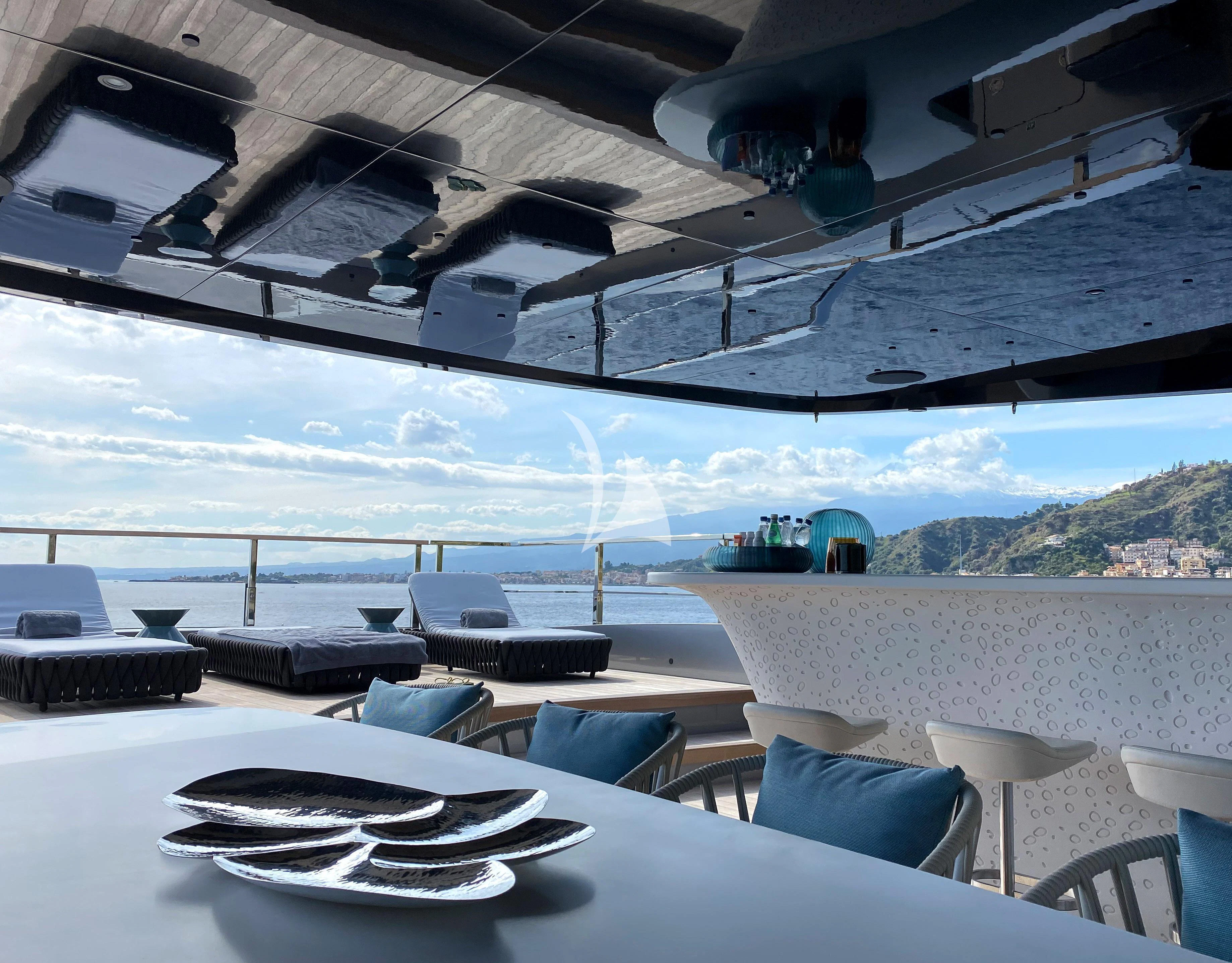 a room with a table and chairs aboard PANDION PEARL Yacht for Charter