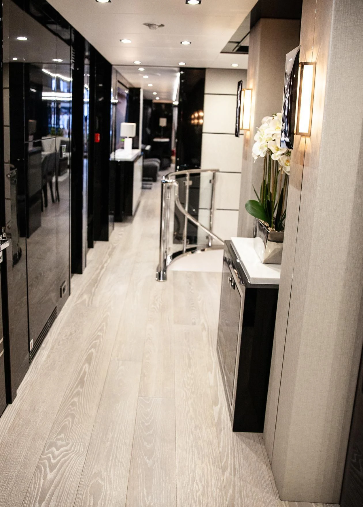 a hallway with a long white counter and black cabinets aboard SONISHI Yacht for Sale