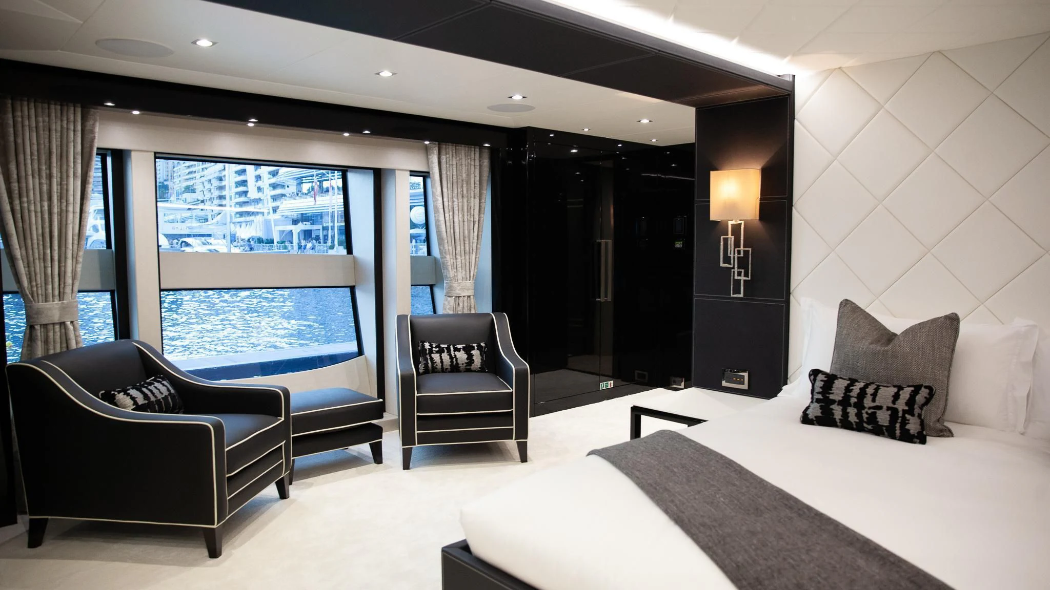 a room with a bed and a chair and a window aboard SONISHI Yacht for Sale