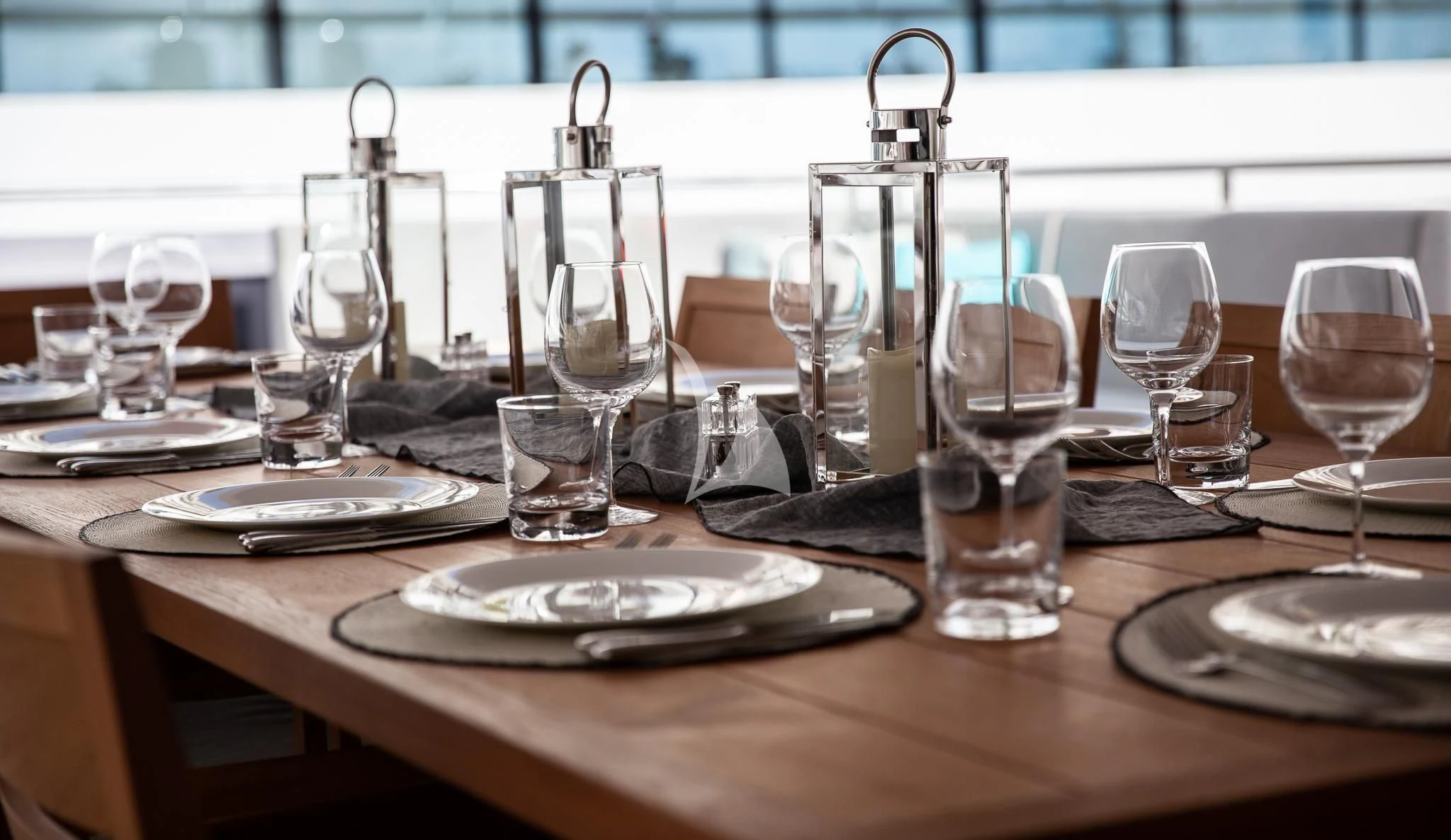a table with wine glasses and plates aboard SONISHI Yacht for Sale