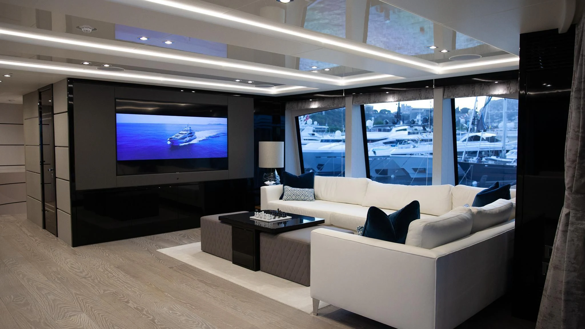 a living room with a large tv aboard SONISHI Yacht for Sale