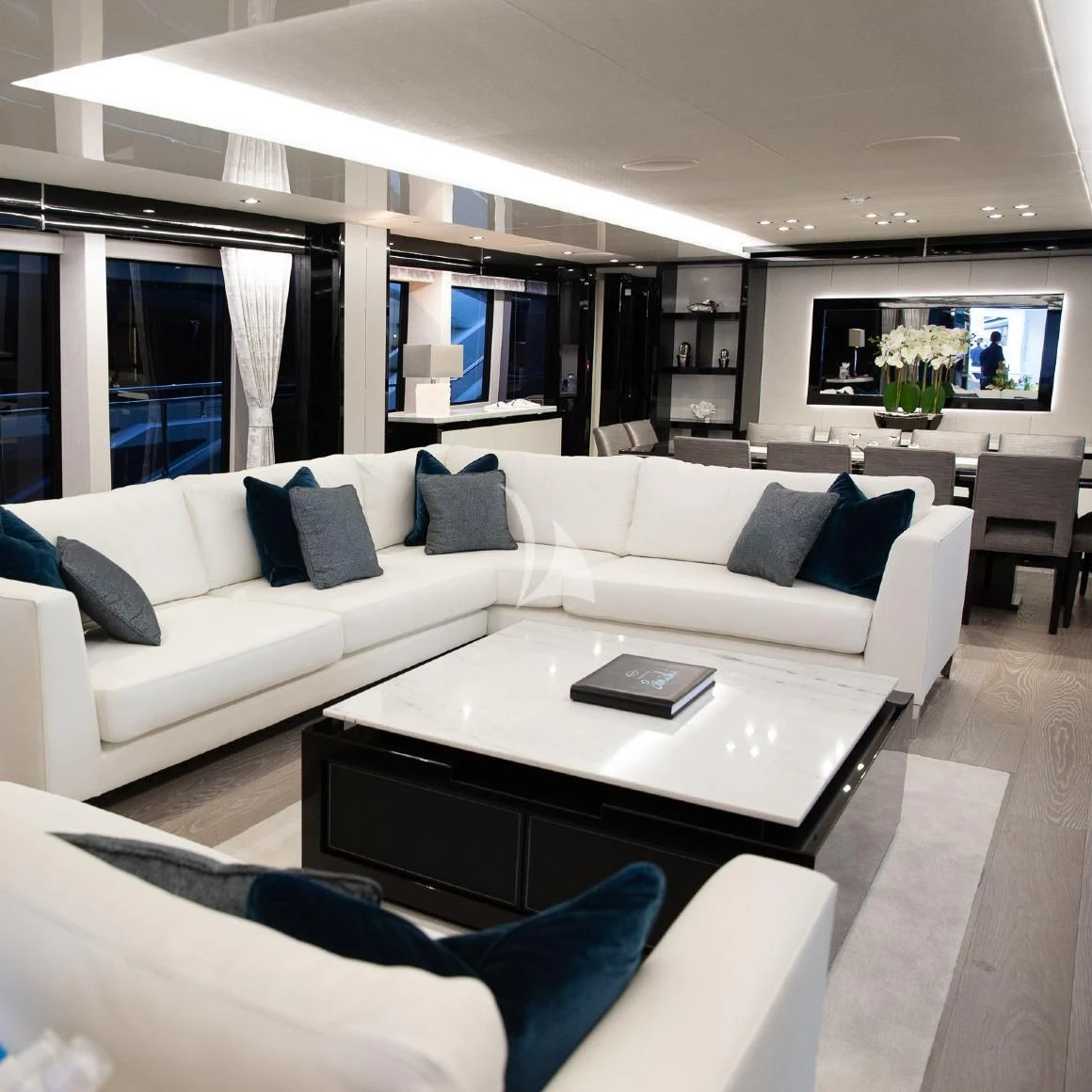 a living room with a white couch aboard SONISHI Yacht for Sale