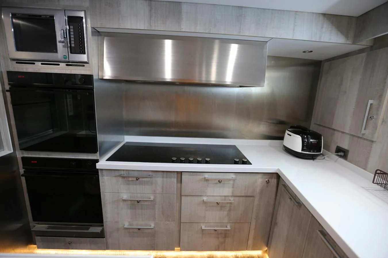 a kitchen with a stainless steel stove and microwave aboard GOODWILL Yacht for Sale