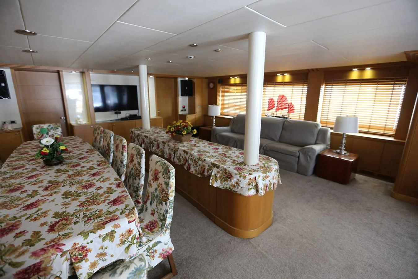 a living room with a large table and couches aboard GOODWILL Yacht for Sale