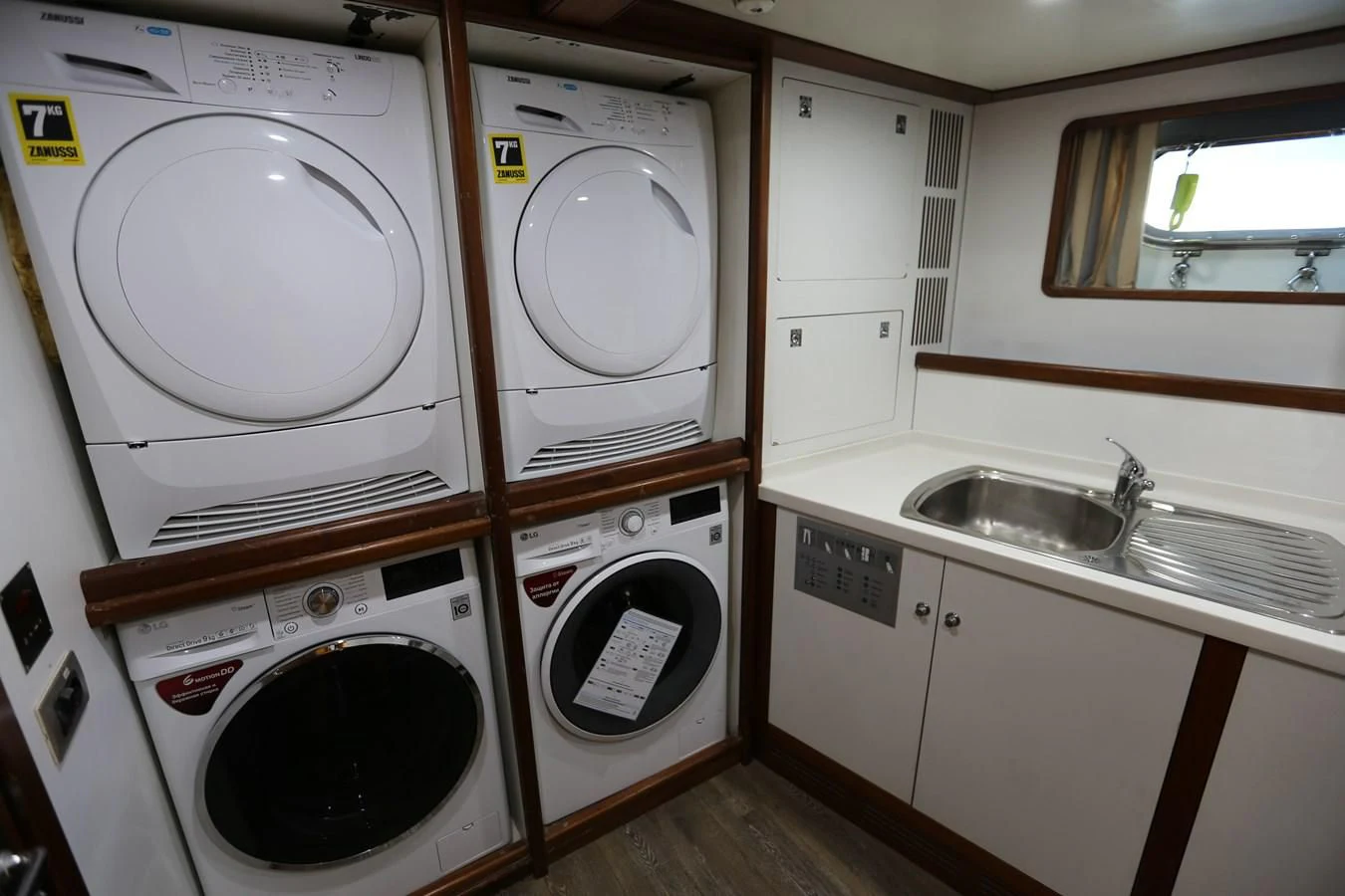 a small kitchen with a washing machine aboard GOODWILL Yacht for Sale