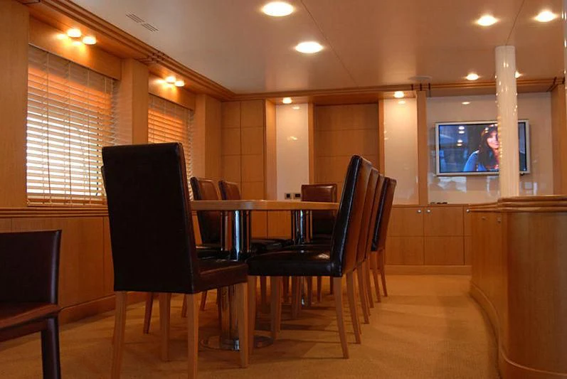 a room with a table and chairs aboard GOODWILL Yacht for Sale