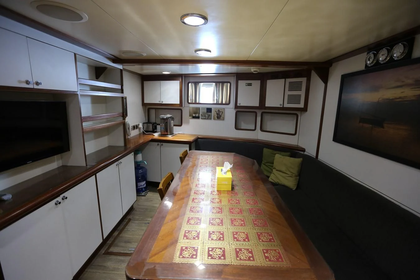 a kitchen with a table and microwave aboard GOODWILL Yacht for Sale