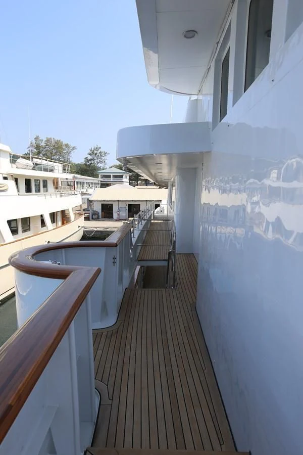 a balcony with a table and chairs aboard GOODWILL Yacht for Sale