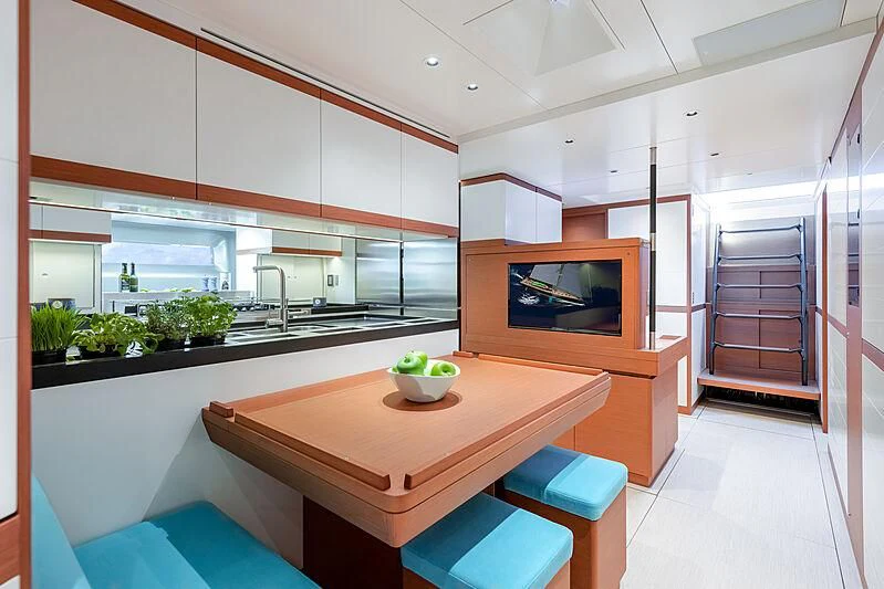 a modern kitchen with a large island aboard MORGANA Yacht for Sale