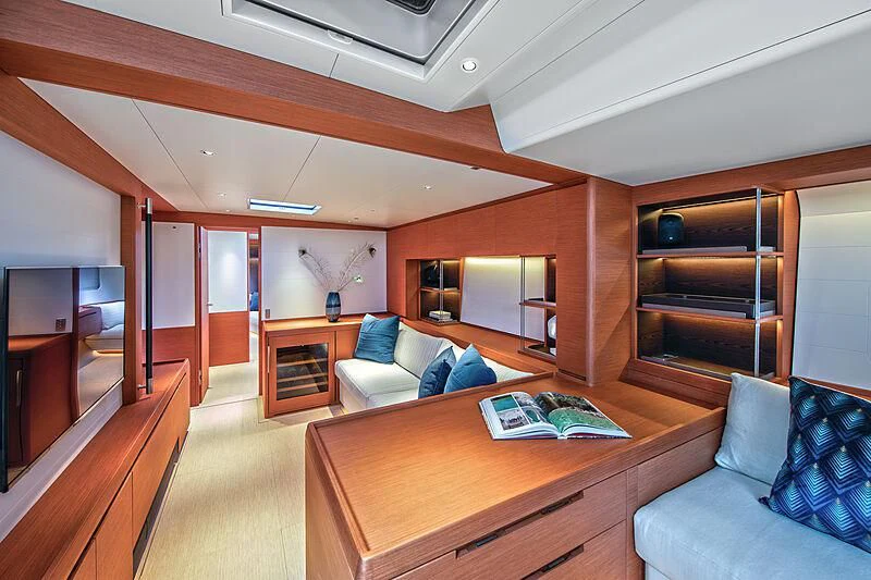 a living room with a large wood table and a large window aboard MORGANA Yacht for Sale