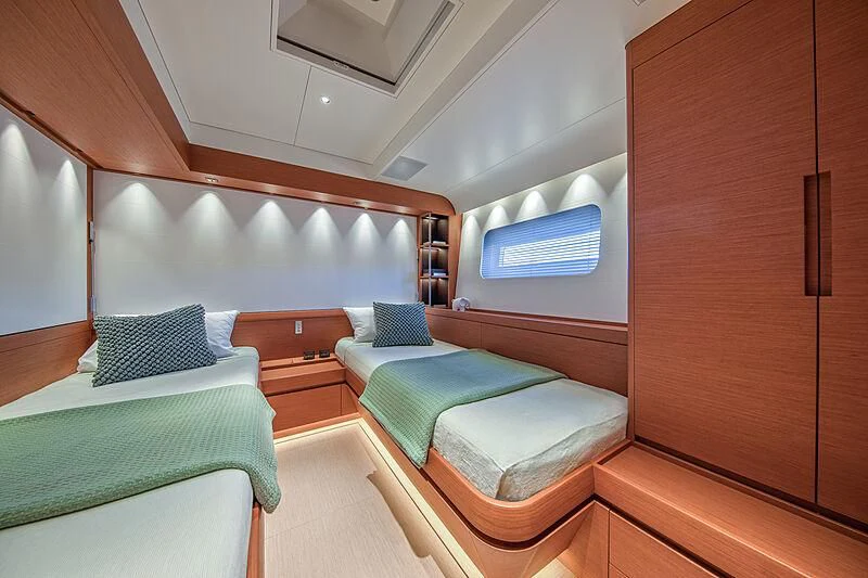 a room with beds and a wood cabinet aboard MORGANA Yacht for Sale