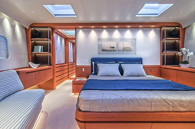 a bedroom with a bed and a bookcase aboard MORGANA Yacht for Sale