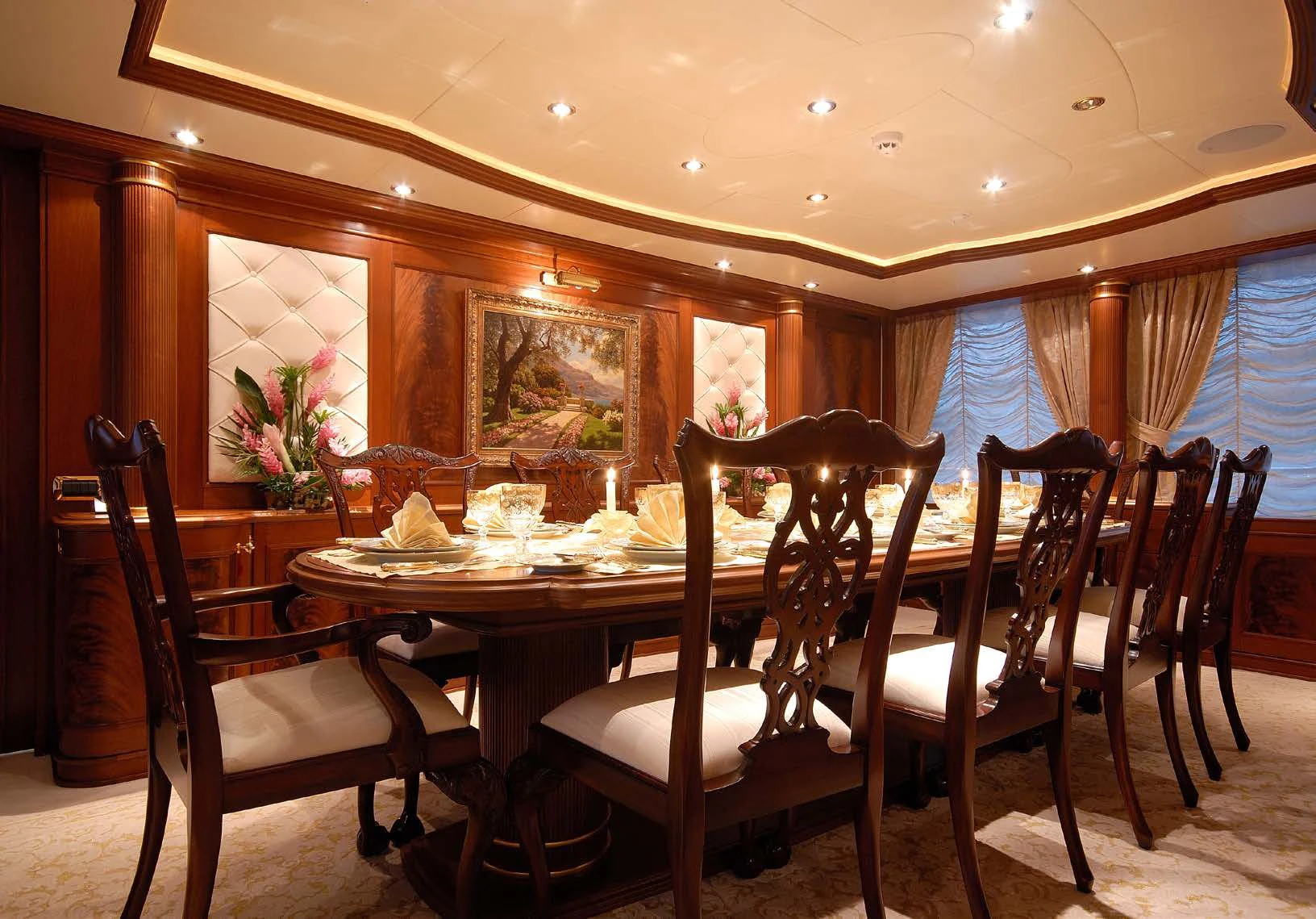 a dining table and chairs in a room with a window aboard AQUAMARINA Yacht for Sale