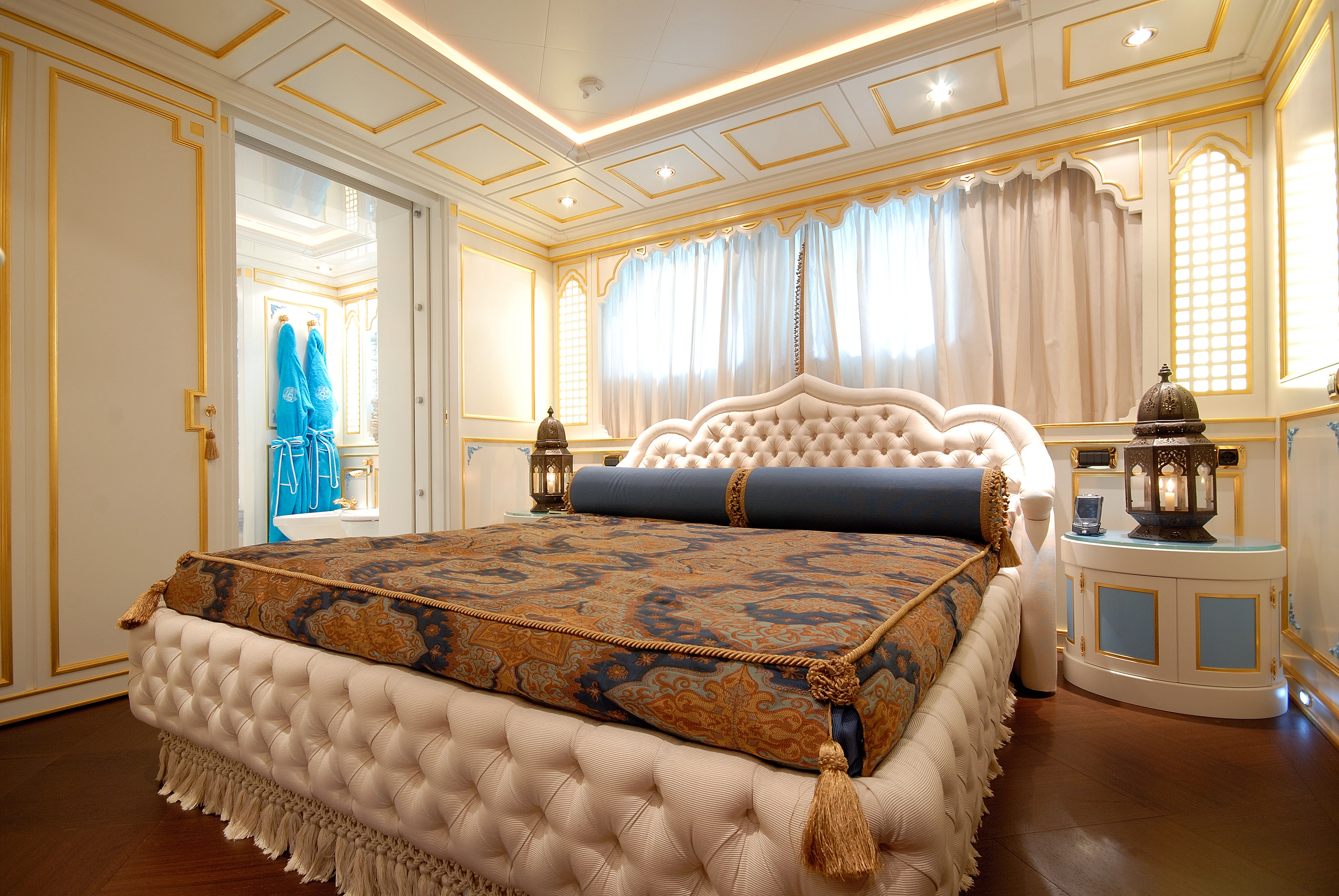 a bedroom with a bed and a dresser aboard AQUAMARINA Yacht for Sale