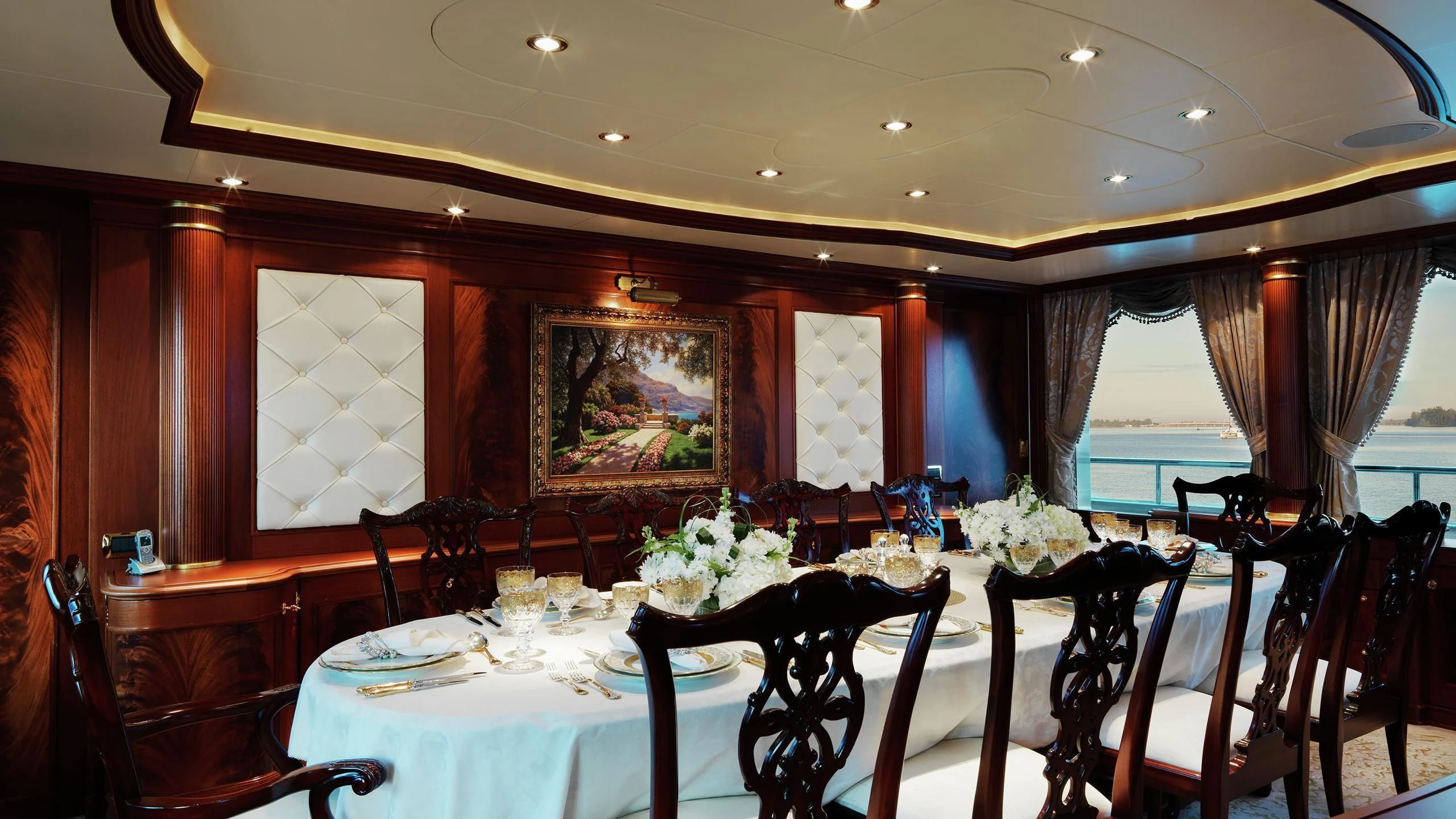 a dining room with a table set for a formal dinner aboard AQUAMARINA Yacht for Sale