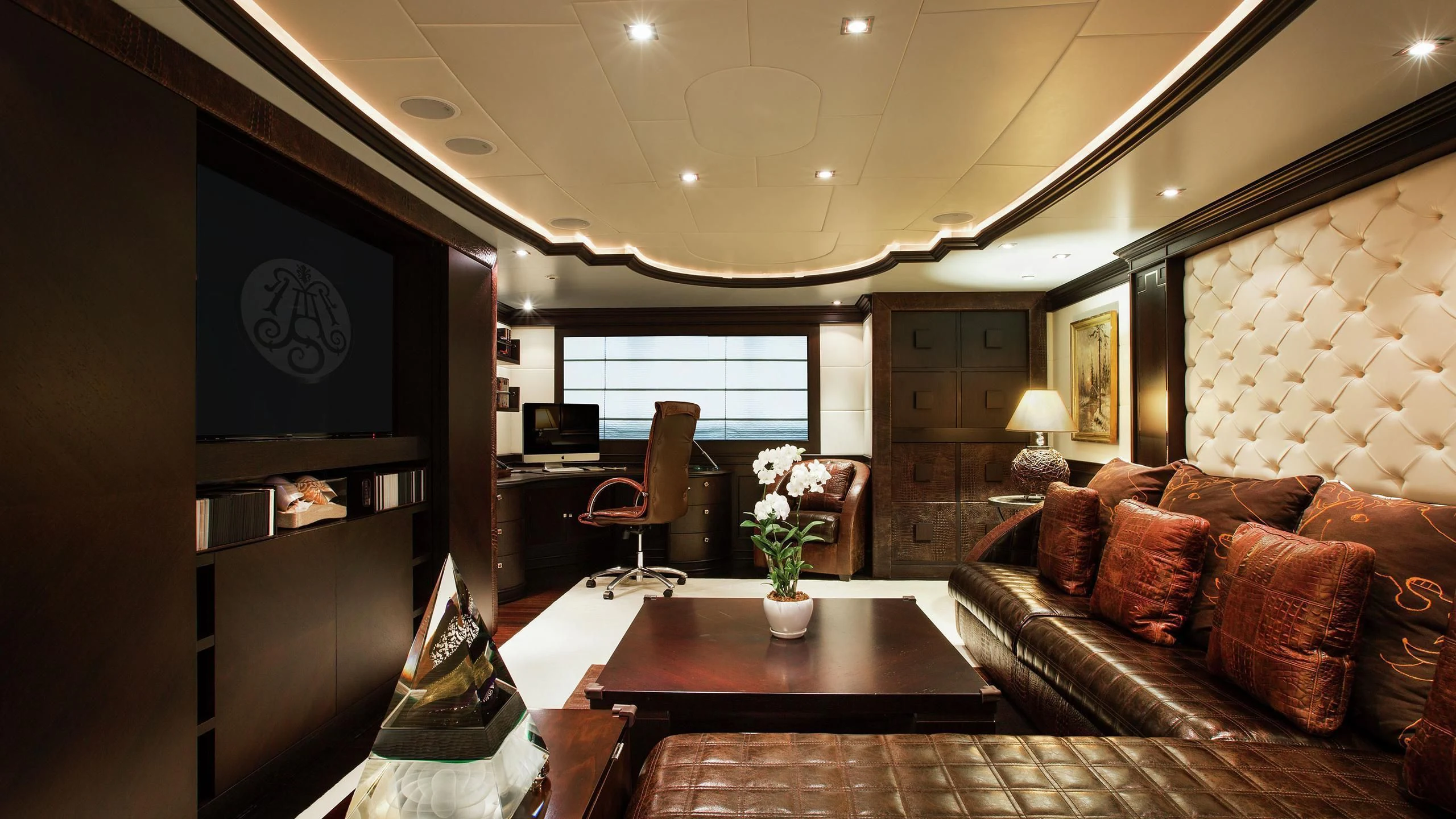 a living room with a leather couch and a television aboard AQUAMARINA Yacht for Sale