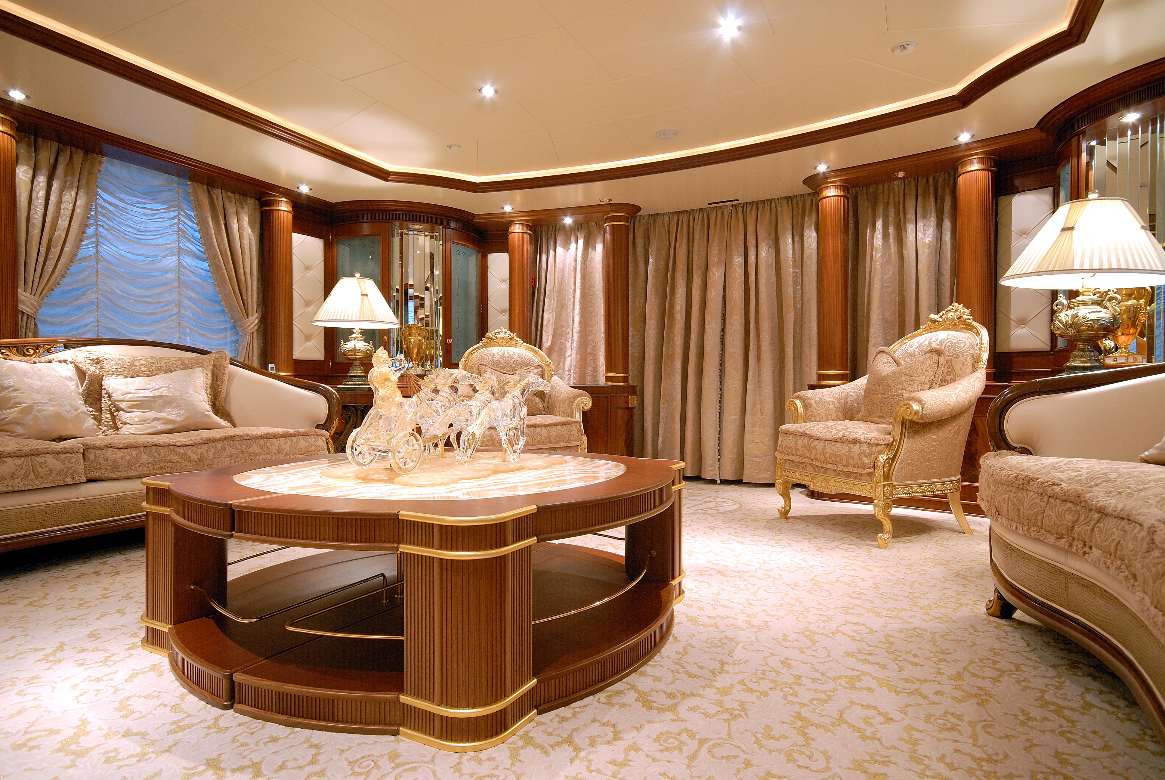 a large living room with a large chandelier aboard AQUAMARINA Yacht for Sale