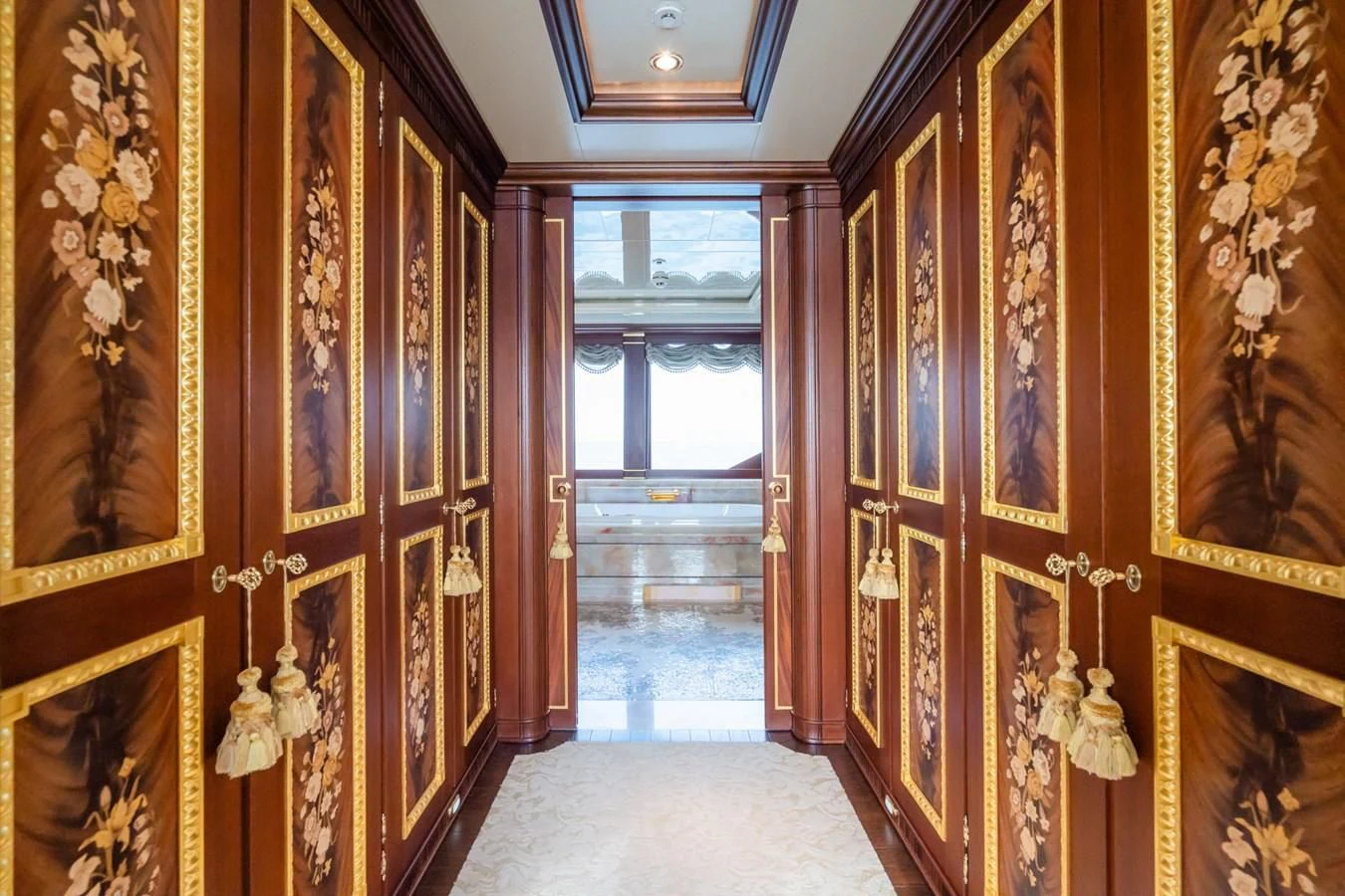 a hallway with gold and red curtains aboard AQUAMARINA Yacht for Sale