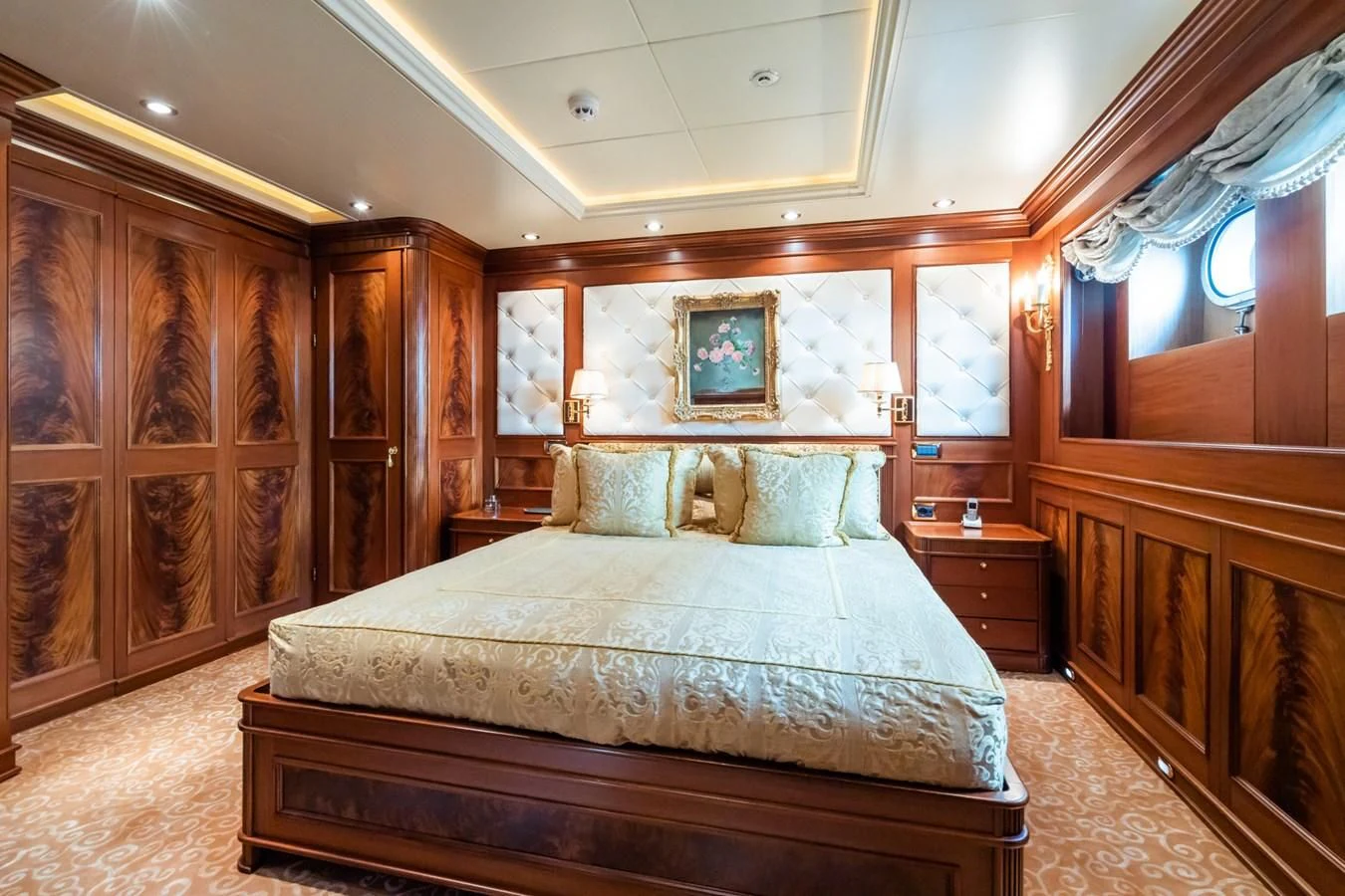 a bed with a blue comforter aboard AQUAMARINA Yacht for Sale