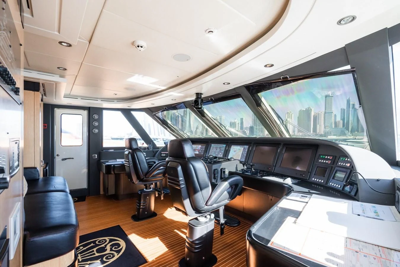 inside of a vehicle with a large window and a desk with chairs and a large window aboard AQUAMARINA Yacht for Sale
