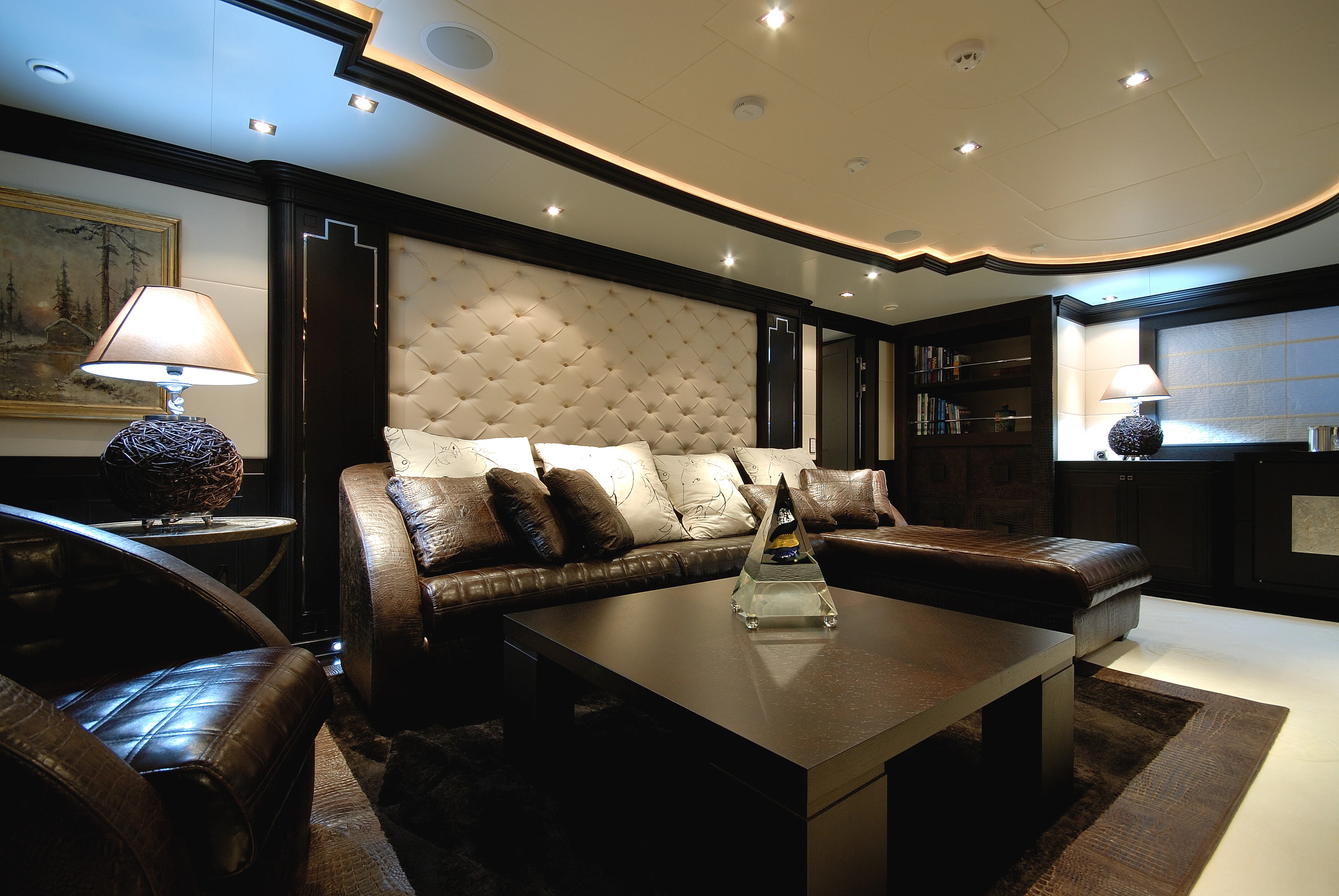 a living room with a large couch and a coffee table aboard AQUAMARINA Yacht for Sale