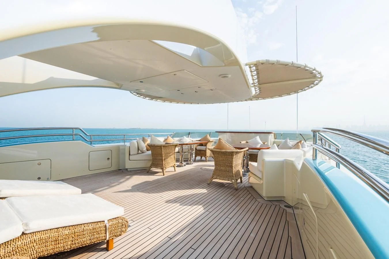 a room with a deck and chairs aboard AQUAMARINA Yacht for Sale