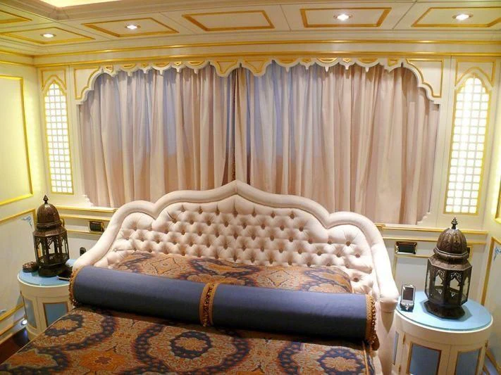 a bed with a blue blanket aboard AQUAMARINA Yacht for Sale