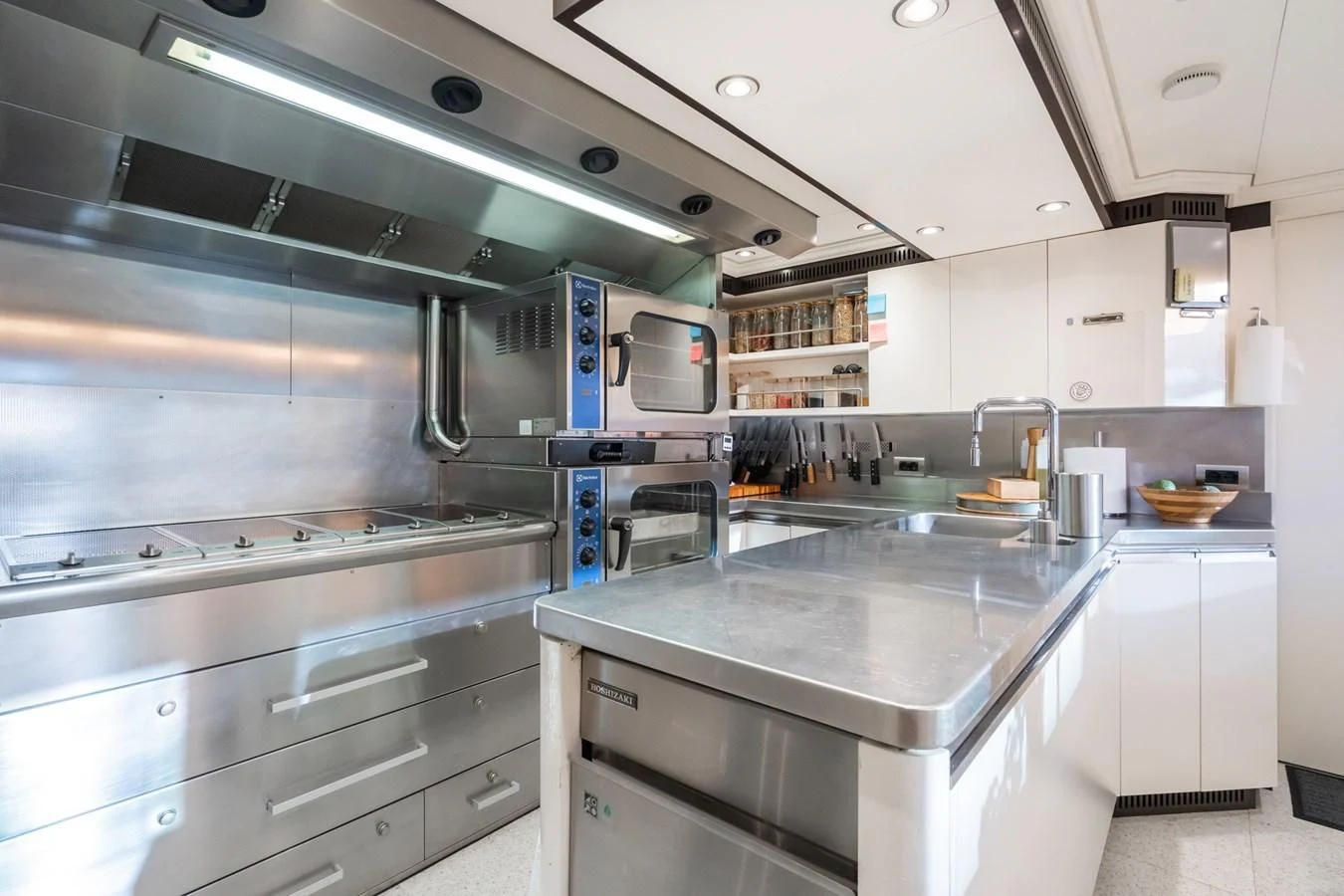 a kitchen with stainless steel appliances aboard AQUAMARINA Yacht for Sale
