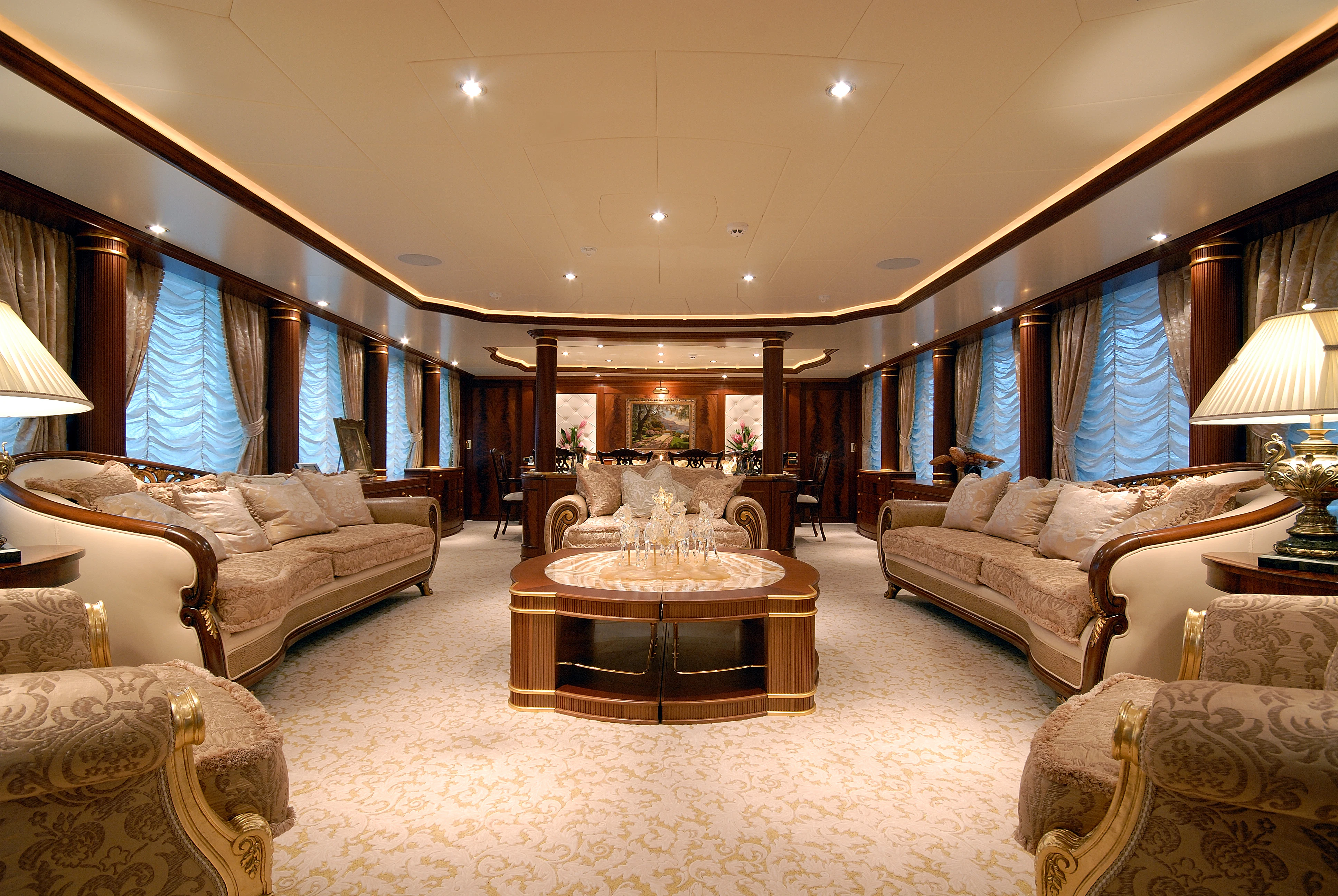 a large living room with a large fireplace aboard AQUAMARINA Yacht for Sale