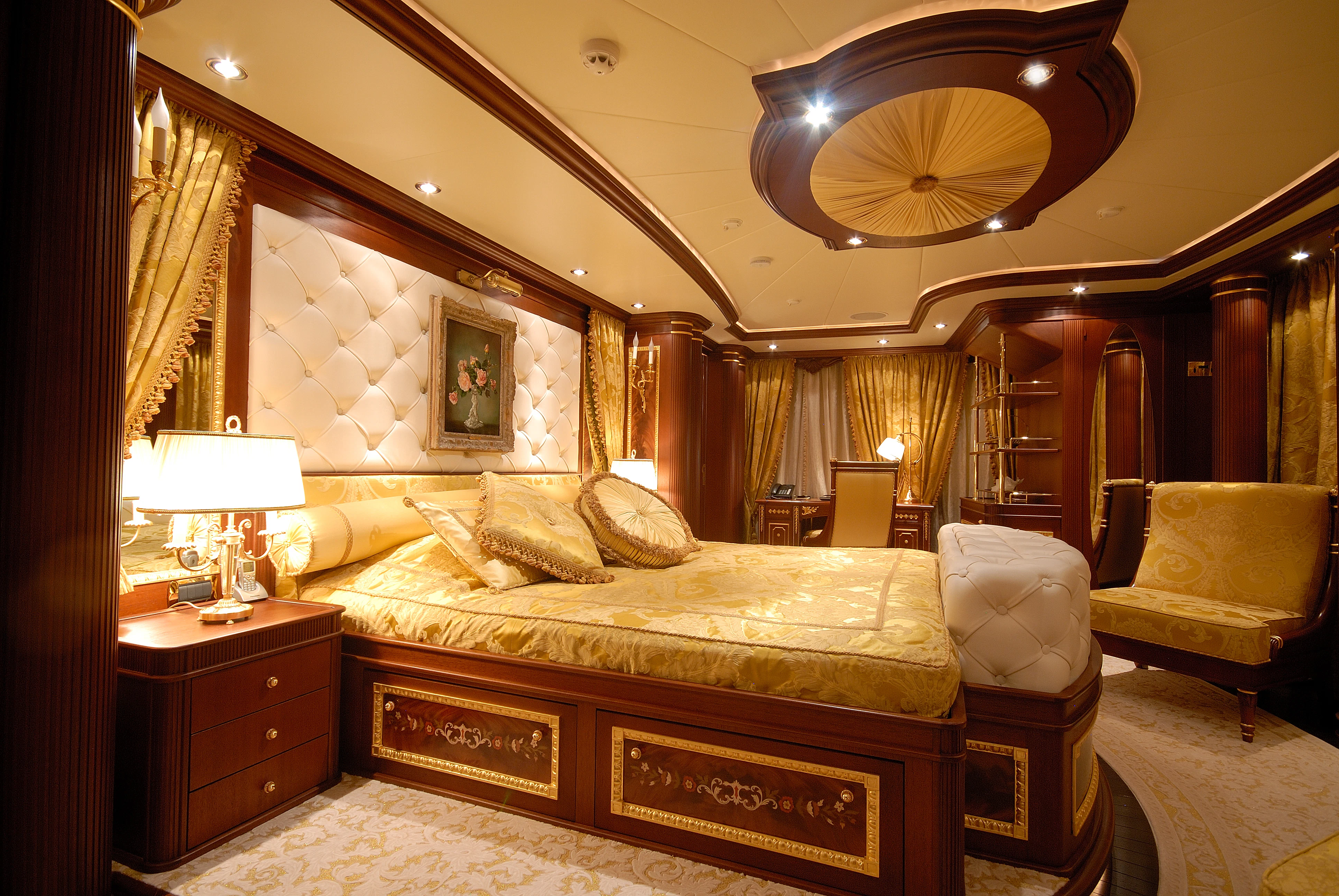 a large bedroom with a bed and a chandelier aboard AQUAMARINA Yacht for Sale