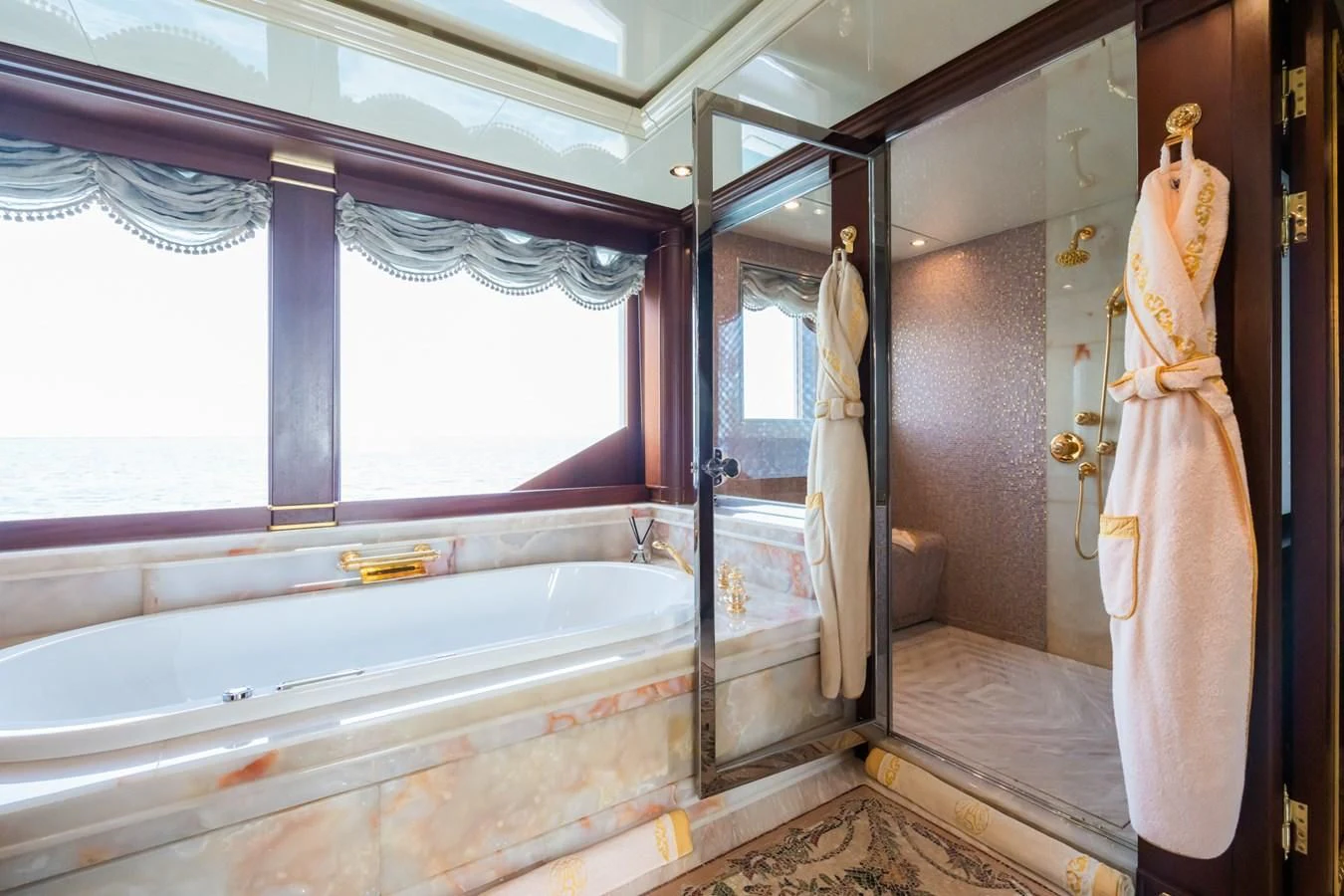 a bathroom with a bathtub and sink aboard AQUAMARINA Yacht for Sale