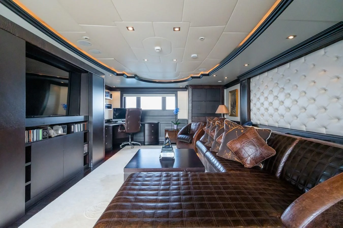 a living room with leather couches aboard AQUAMARINA Yacht for Sale
