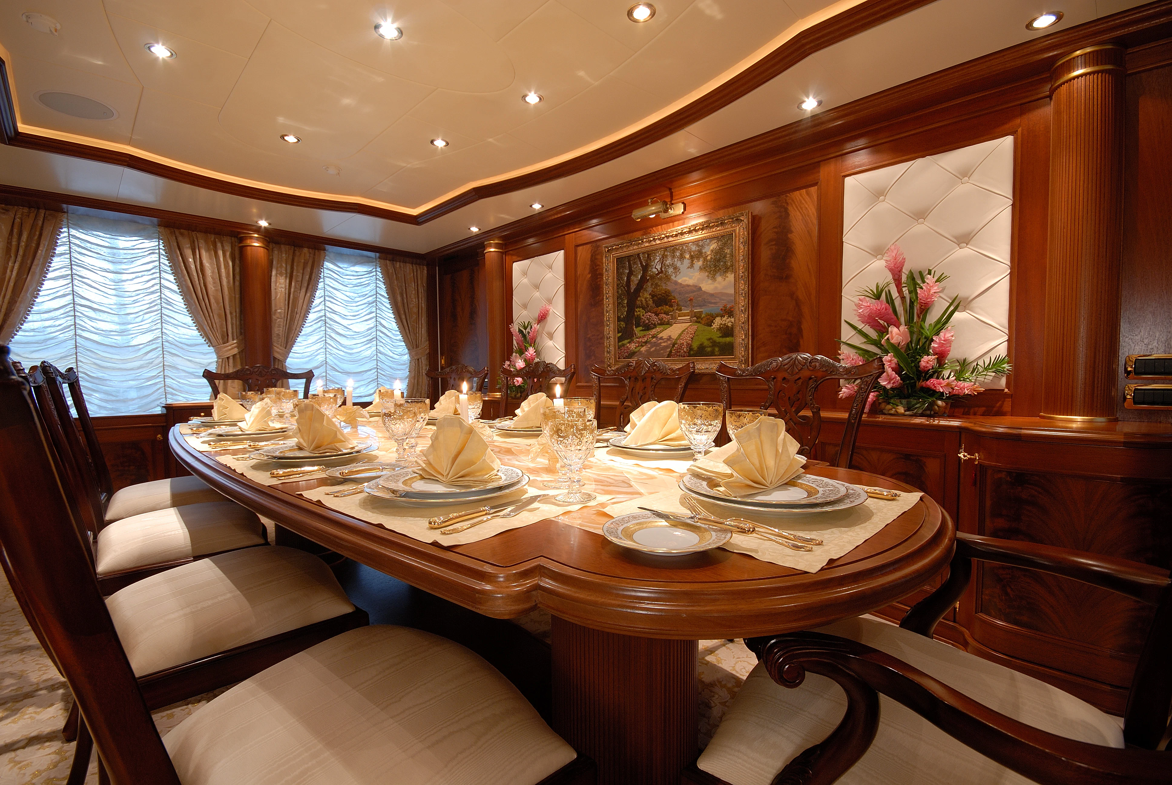 a dining table with a set of chairs and a large window aboard AQUAMARINA Yacht for Sale