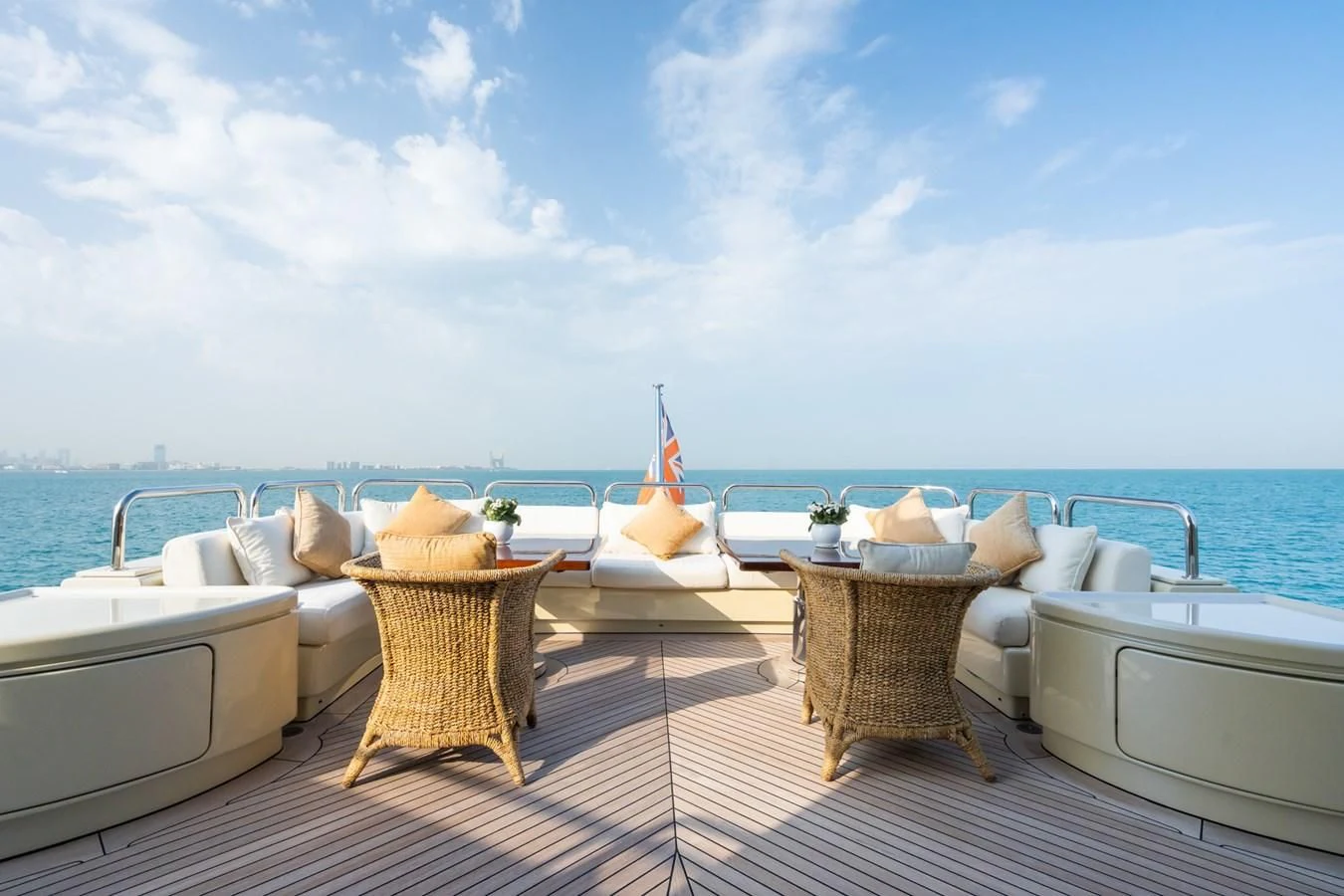 a deck with a view of the ocean and a large boat aboard AQUAMARINA Yacht for Sale