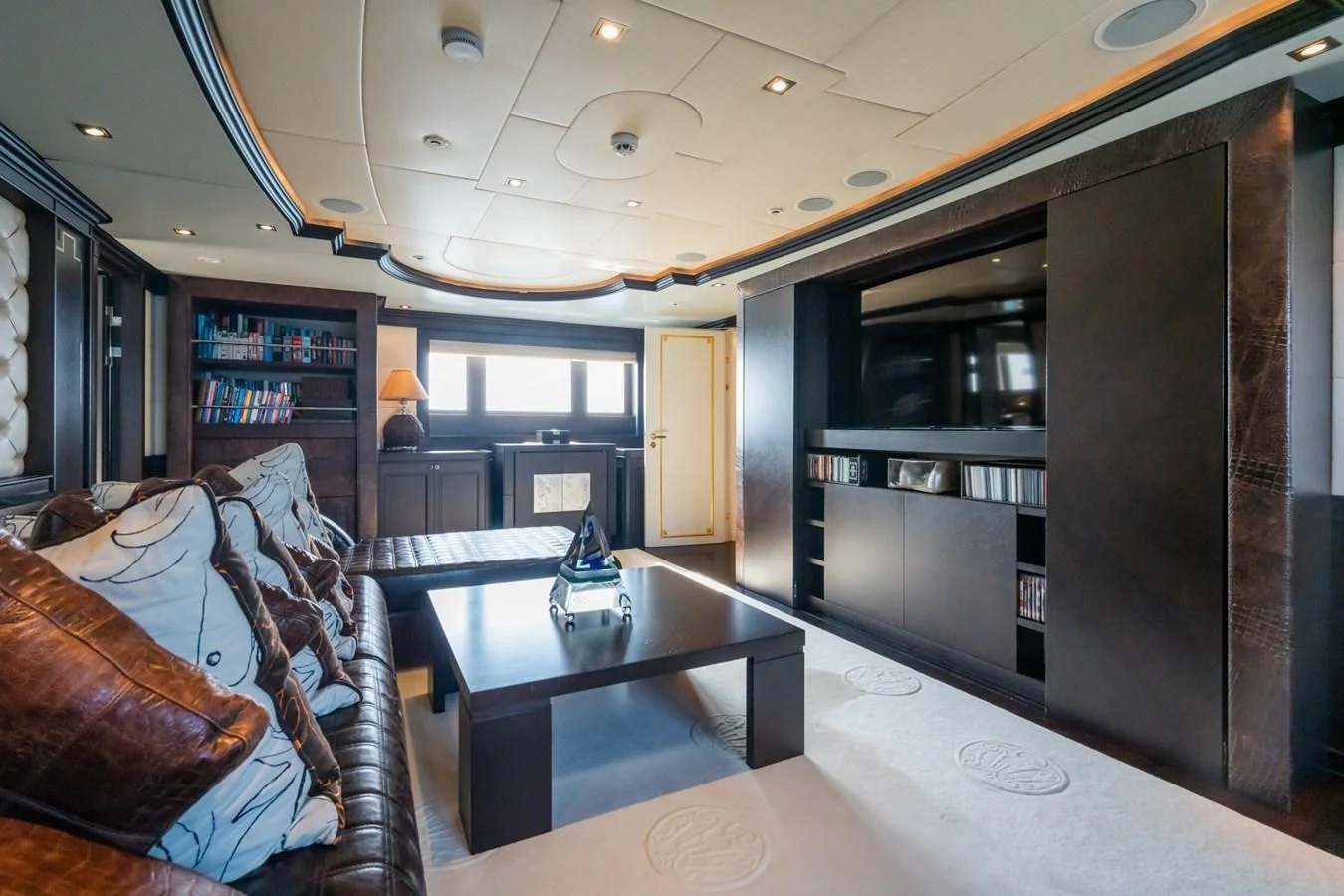 a living room with a leather couch and a coffee table aboard AQUAMARINA Yacht for Sale