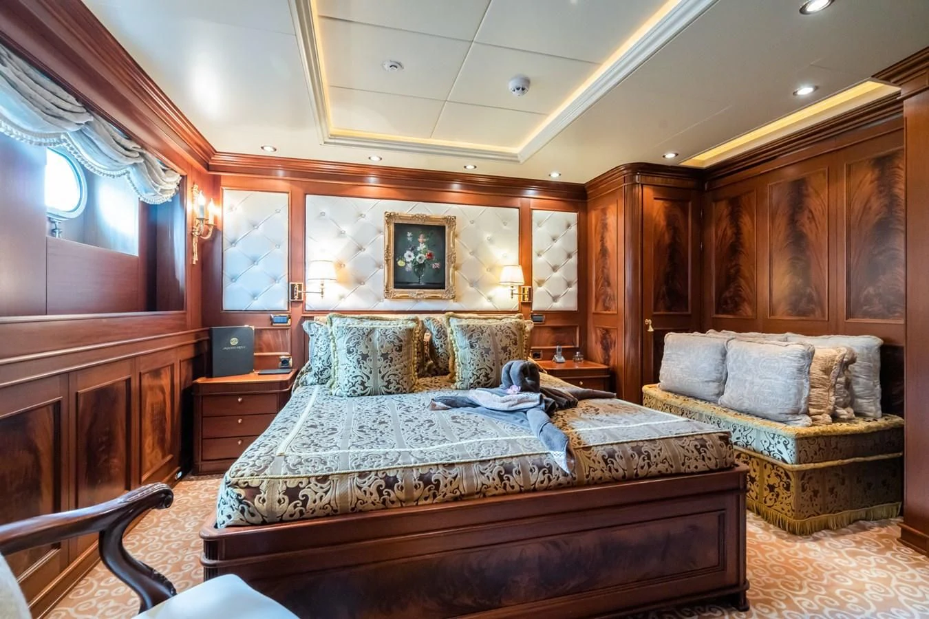 a bedroom with a bed and a large teddy bear aboard AQUAMARINA Yacht for Sale