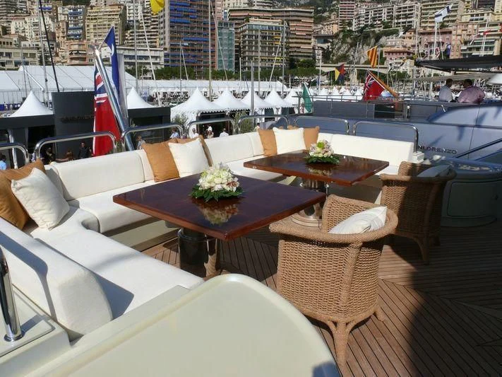tables and chairs on a deck aboard AQUAMARINA Yacht for Sale