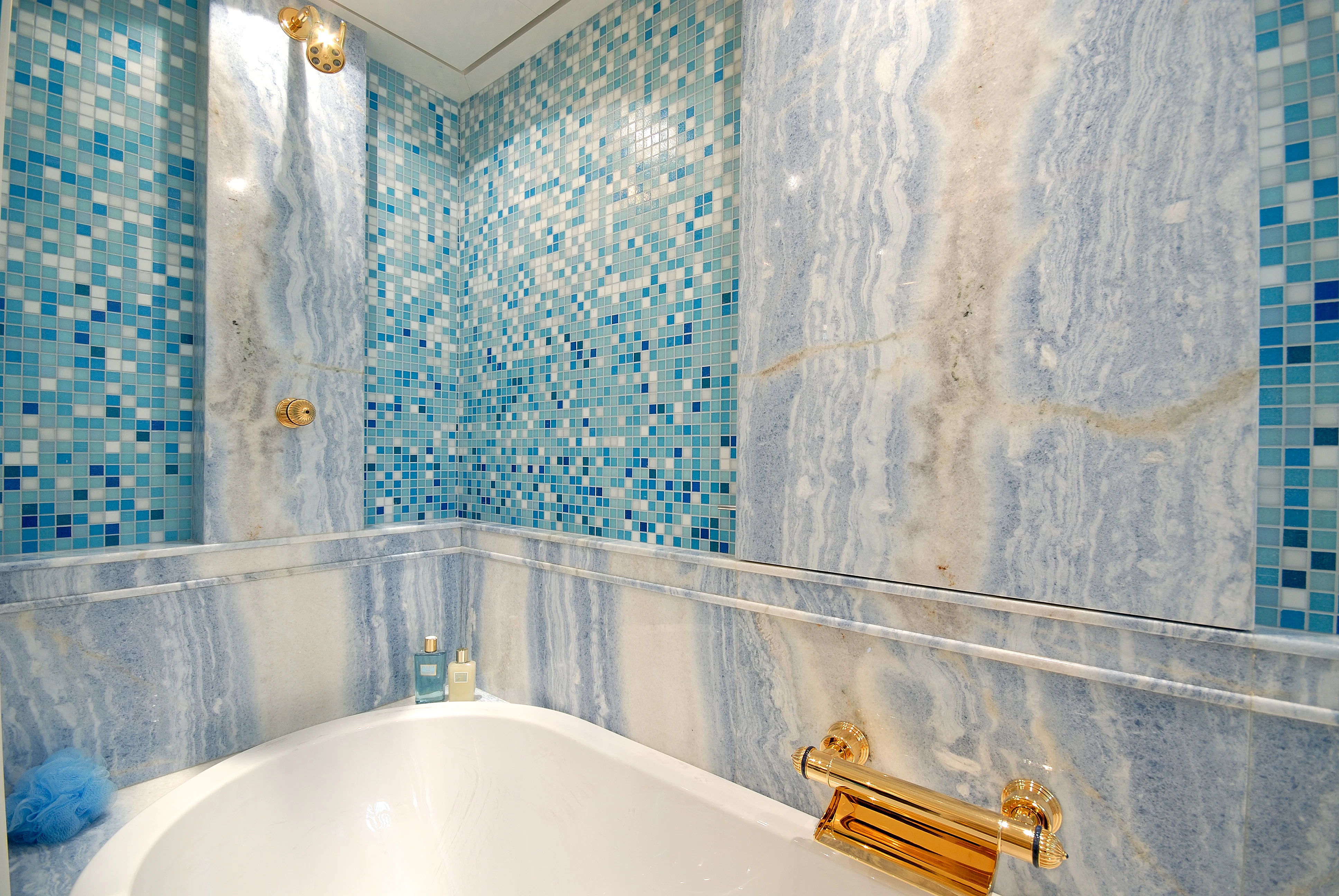 a bathroom with a bathtub and shower aboard AQUAMARINA Yacht for Sale