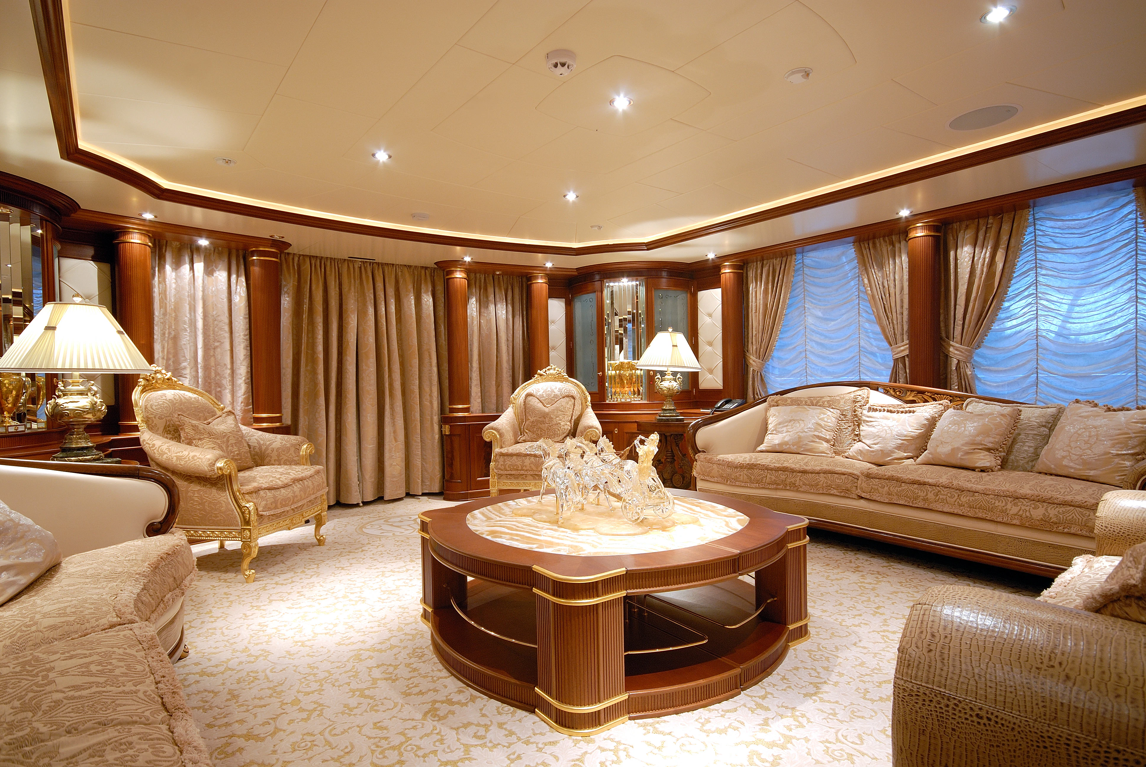 a living room with a large table and couches aboard AQUAMARINA Yacht for Sale