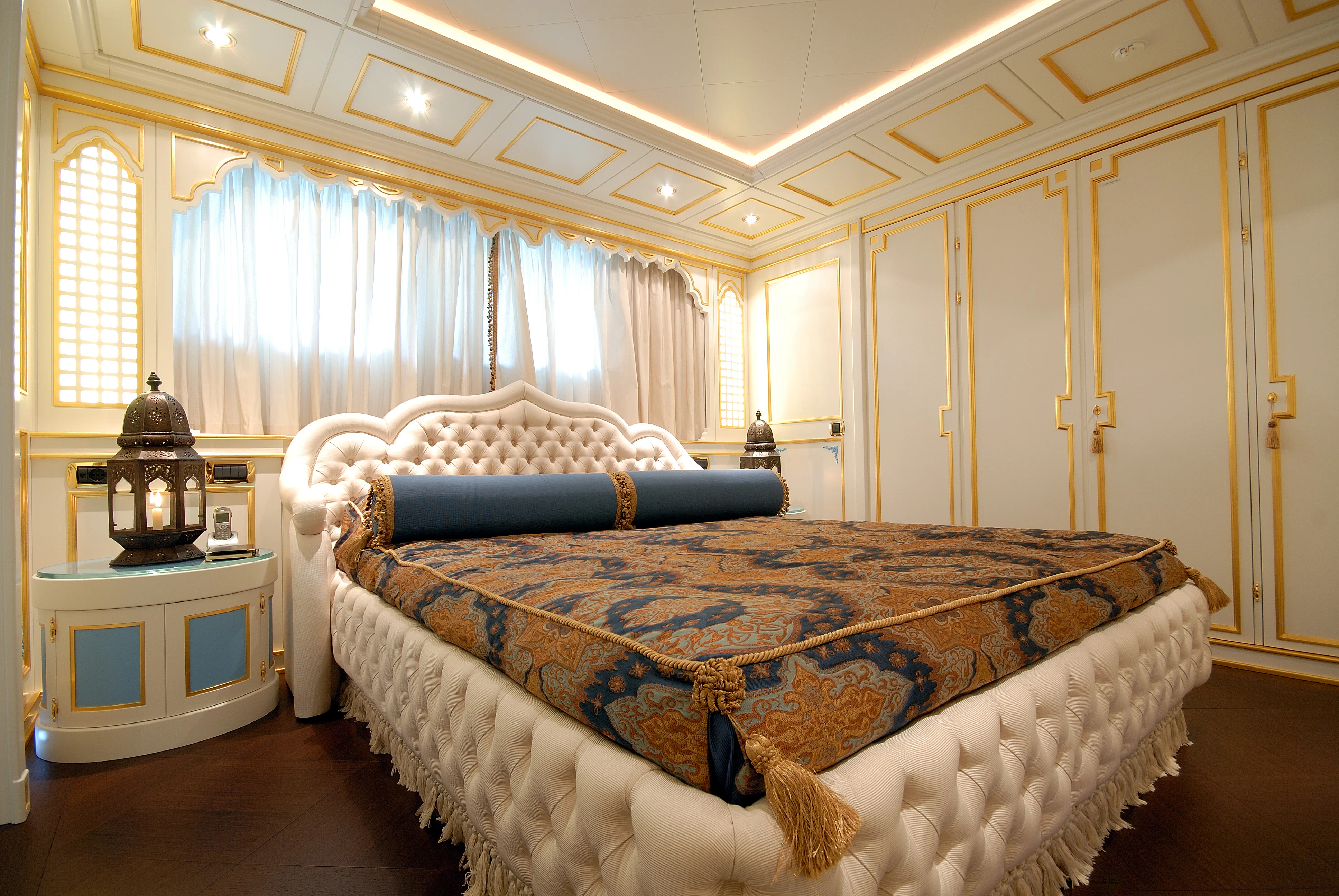 a bedroom with a bed and a lamp aboard AQUAMARINA Yacht for Sale