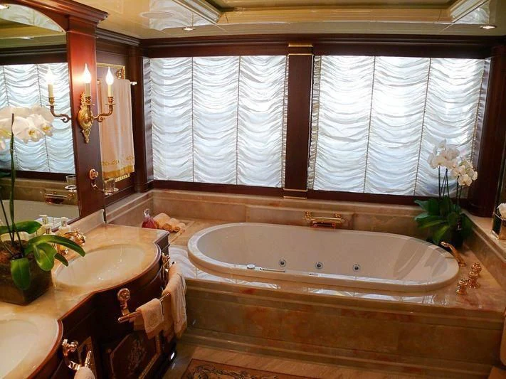 a bathroom with a tub sink and a sink aboard AQUAMARINA Yacht for Sale