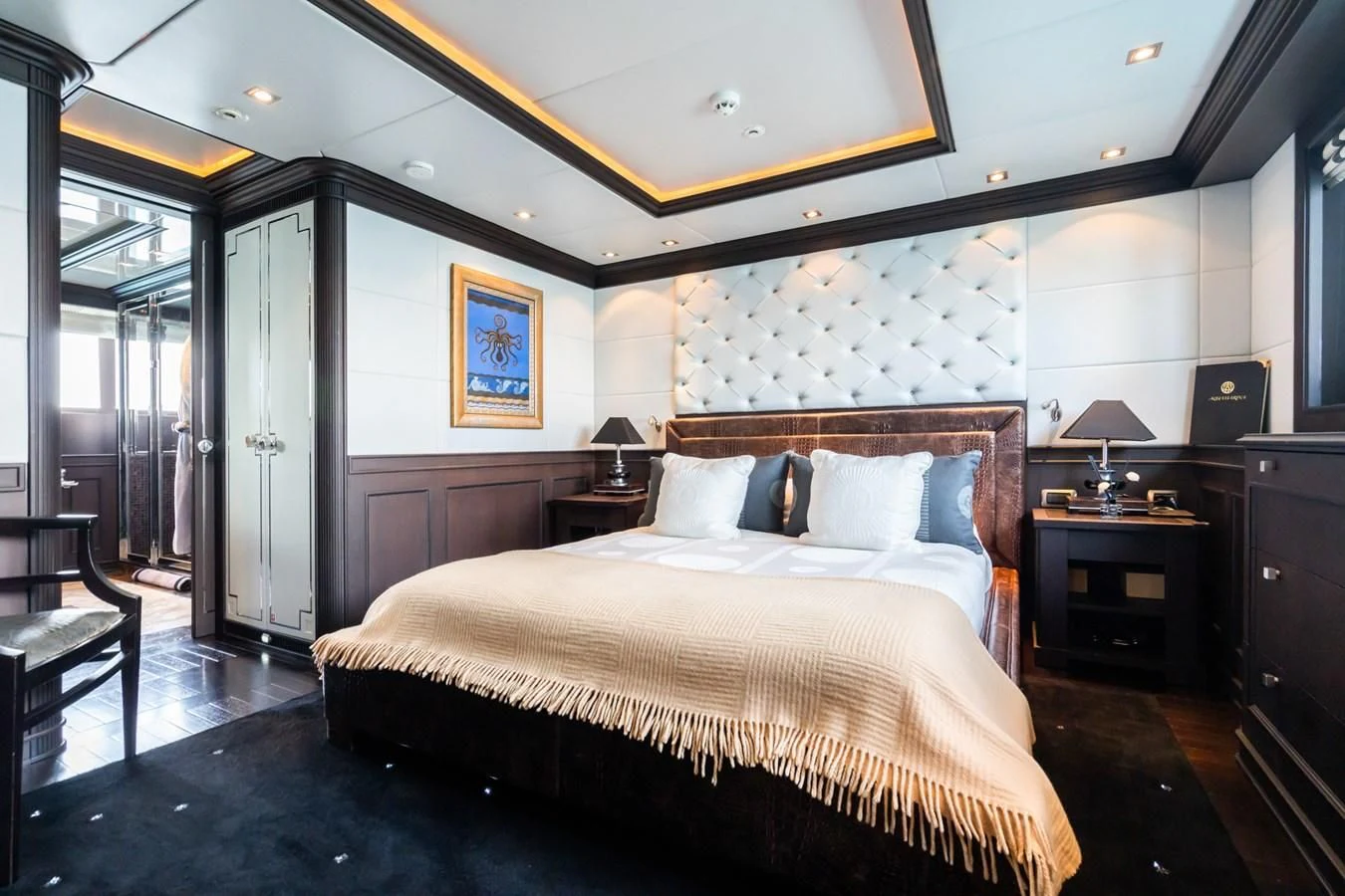 a bedroom with a bed and a desk aboard AQUAMARINA Yacht for Sale