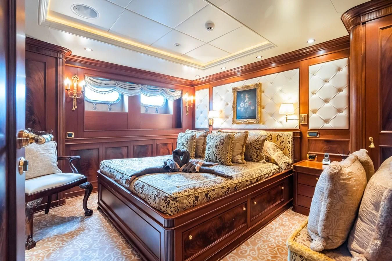 a bedroom with a bed and a couple of dogs on the bed aboard AQUAMARINA Yacht for Sale