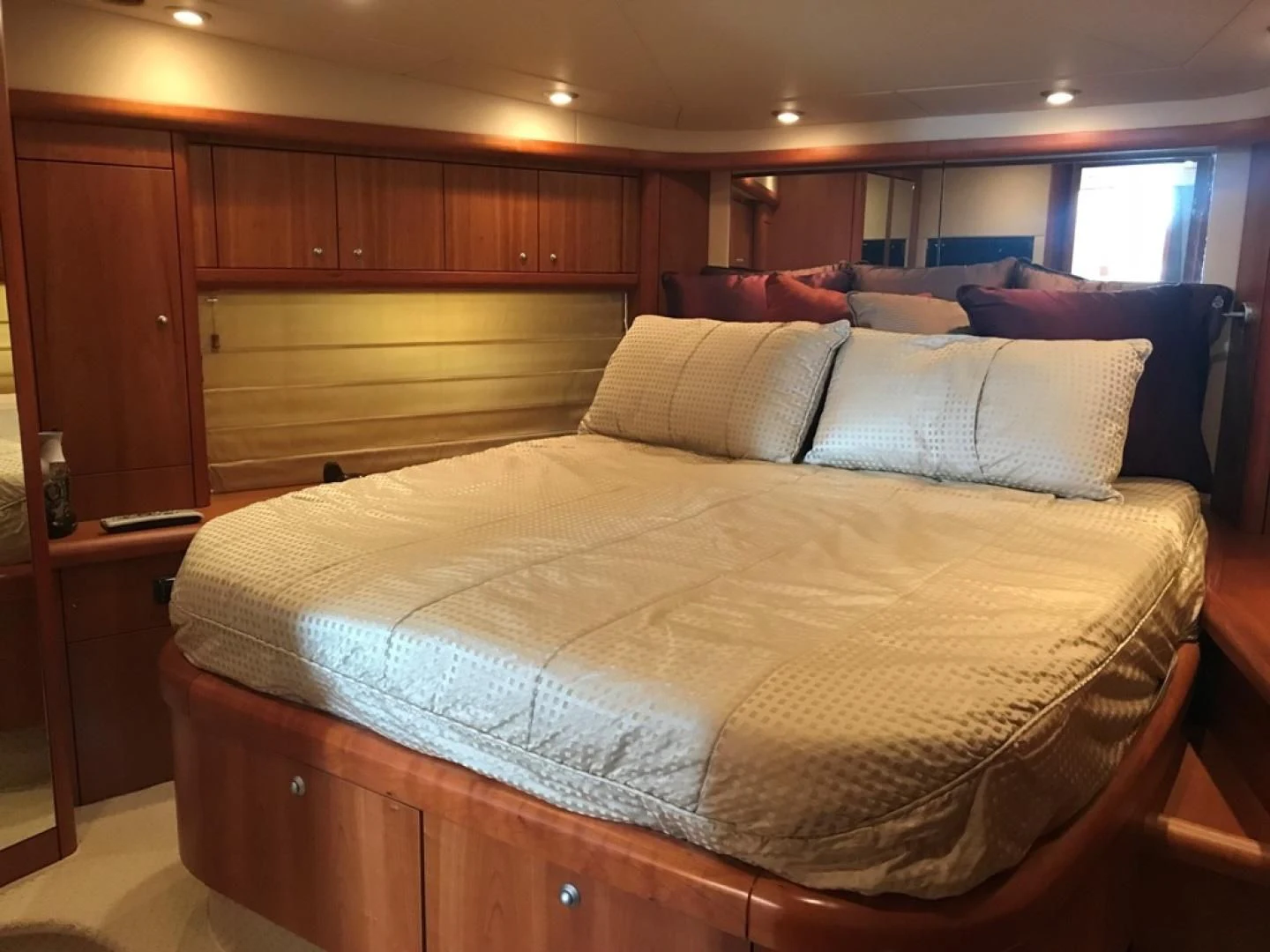 a bed with a white comforter aboard DAY DREAMER Yacht for Sale