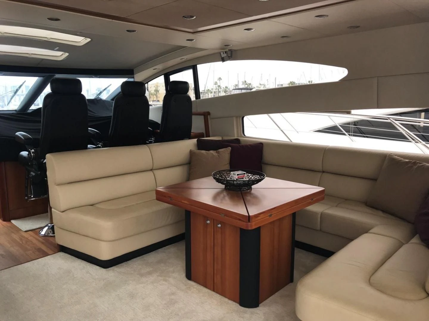 a room with a table and couch aboard DAY DREAMER Yacht for Sale